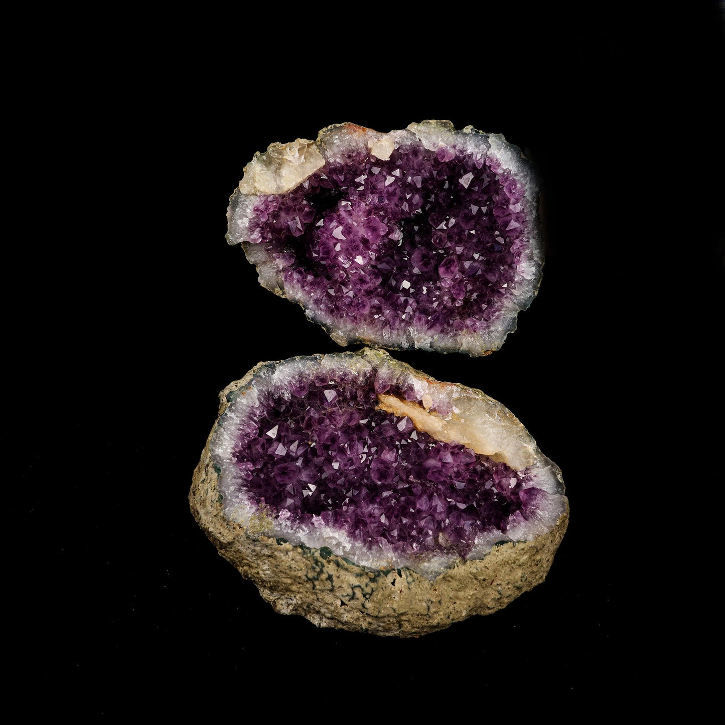 Amethyst Geode with Calcite Unopened Natural Mineral Specimen # B 522…  https://www.superbminerals.us/products/amethyst-geode-with-calcite-unopened-natural-mineral-specimen-b-5226  Features: This essay highlights the importance of never judging a book by its cover. When you look at these two halves together, it's plain and unappealing. Even unappealing. It's a breathtaking contrast to see the sparkling, purple Amethyst crystals lining the entire chamber on both half as it splits apart!