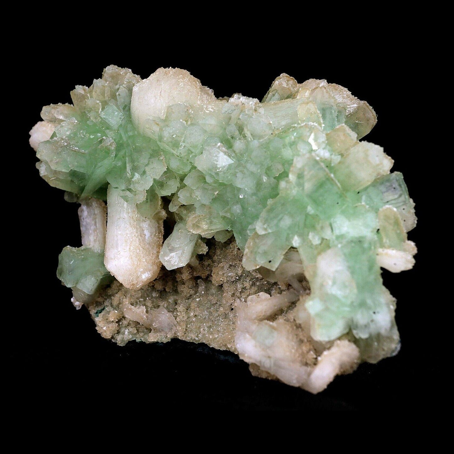 Apophyllite Green Crystal with Stilbite Natural Mineral Specimen # B 3571 https://www.superbminerals.us/products/apophyllite-green-crystal-with-stilbite-natural-mineral-specimen-b-3571 An extremely stylish piece that that is covered with light green Apophyllite precious stones. Set among the Apophyllite gems are various Stilbite gems, a few having a "tie" precious stone development. The silvery shine of this piece is extraordinary. You will see some uncovered lattice of beige-shaded microcry