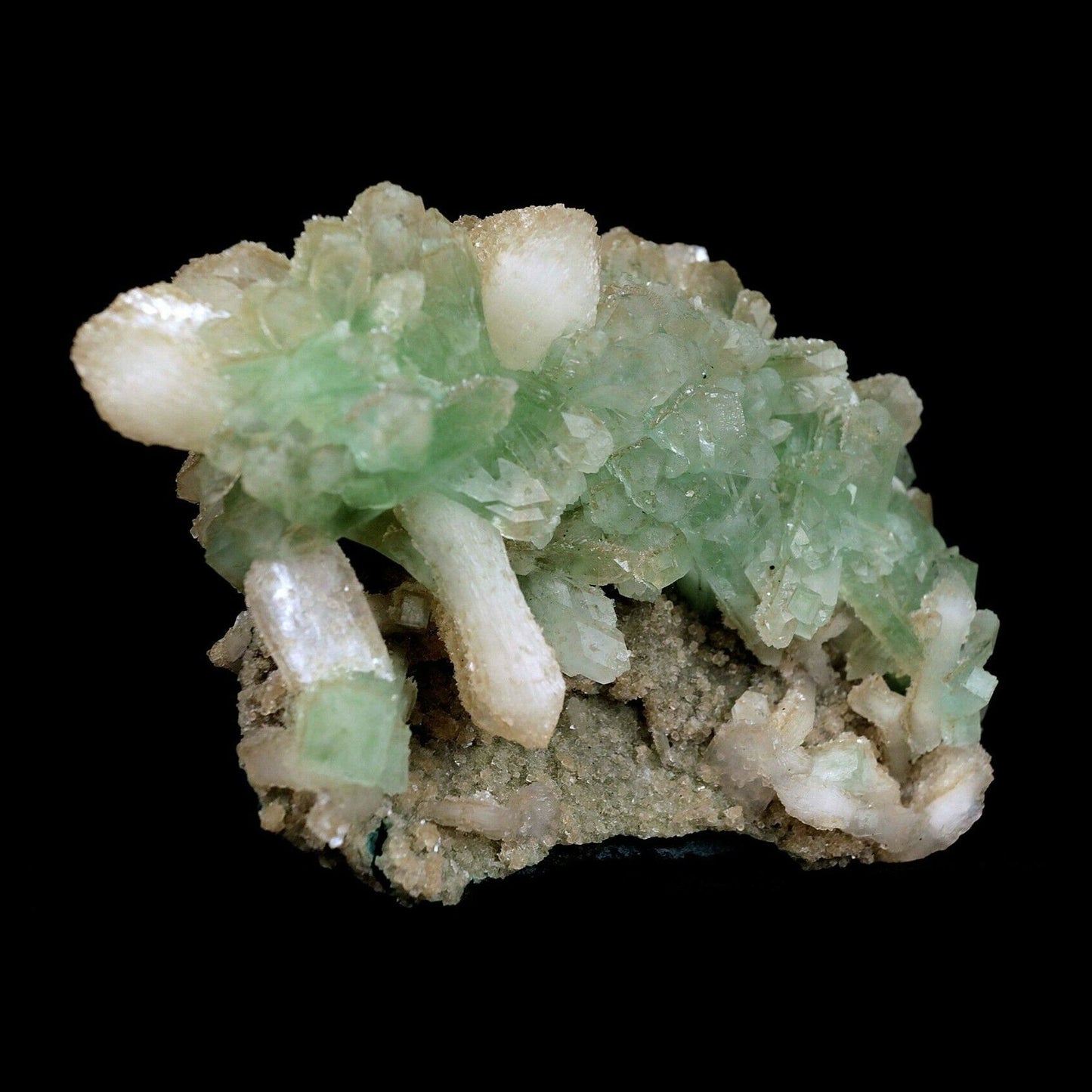 Apophyllite Green Crystal with Stilbite Natural Mineral Specimen # B 3571 https://www.superbminerals.us/products/apophyllite-green-crystal-with-stilbite-natural-mineral-specimen-b-3571 An extremely stylish piece that that is covered with light green Apophyllite precious stones. Set among the Apophyllite gems are various Stilbite gems, a few having a "tie" precious stone development. The silvery shine of this piece is extraordinary. You will see some uncovered lattice of beige-shaded microcry