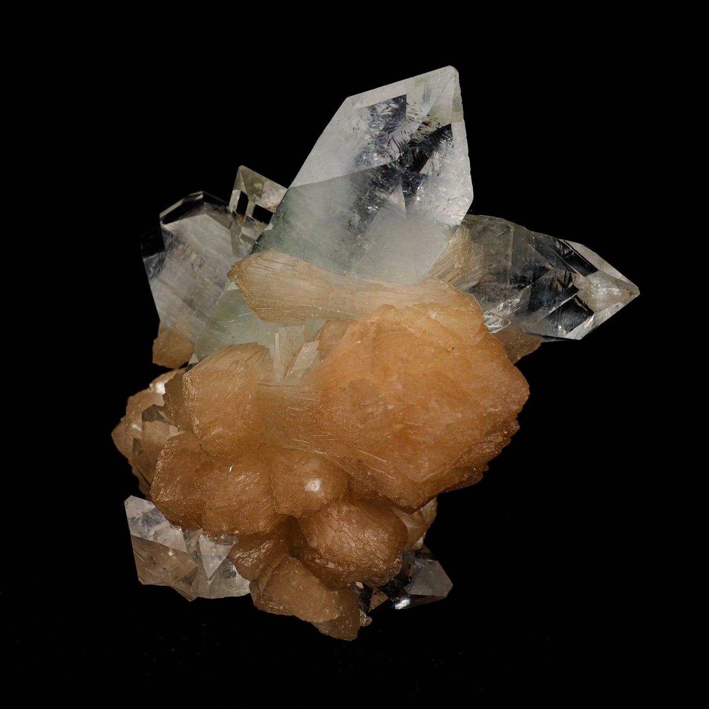 Apophyllite Pointed with Stilbite Natural Mineral Specimen # B 5098 https://www.superbminerals.us/products/apophyllite-pointed-with-stilbite-natural-mineral-specimen-b-5098 Features: A classic and aesthetic display specimen featuring sharp, lustrous, very well-formed, beautiful orange-peach colored, thick "sword"-shaped sheaf-like crystals of Stilbite across sitting atop of Apophyllite matrix with a distinct pinkish coloring internally. The main Stilbite crystal is doubly