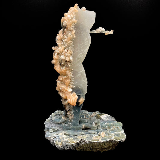 Towering calcite specimen coated in chalcedony and stilbite with a single distinctive, delicate stalactite growing sideways near the top termination, with stilbite blades of its own. The base is blue chalcedony stalactites with basalt on the bottom.