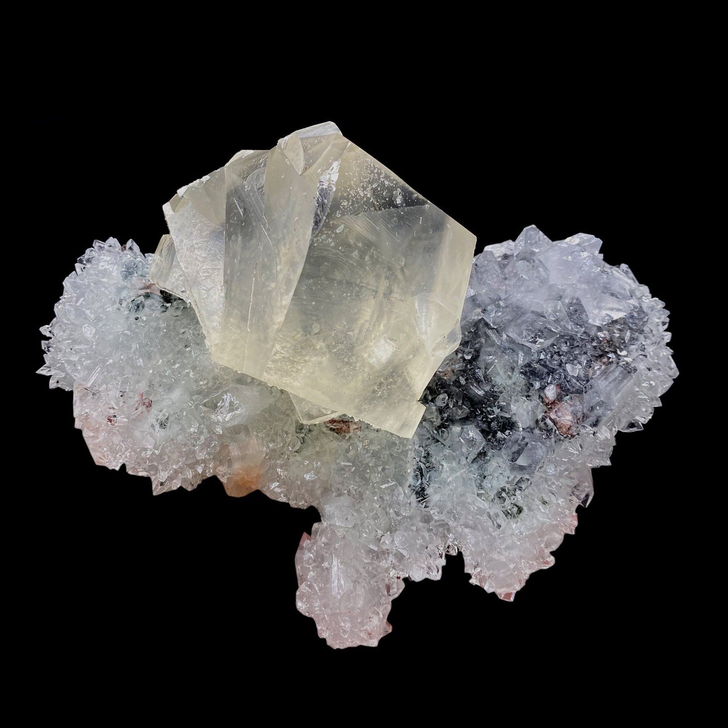 Calcite with Apophyllite on Heuladnite # Q9  https://www.superbminerals.us/products/calcite-with-apophyllite-on-heuladnite-q9  Features:Fascinating specimen of Calcite and impressive mirror lustrous gemmy Apophyllite crystals from superb find in Jalgaon. It displays twin honey colored Calcite Cube, well formed superb flat faces with excellent brilliance and light reflection.&nbsp; Lustrous Calcite crystals grow at the top forming aesthetic