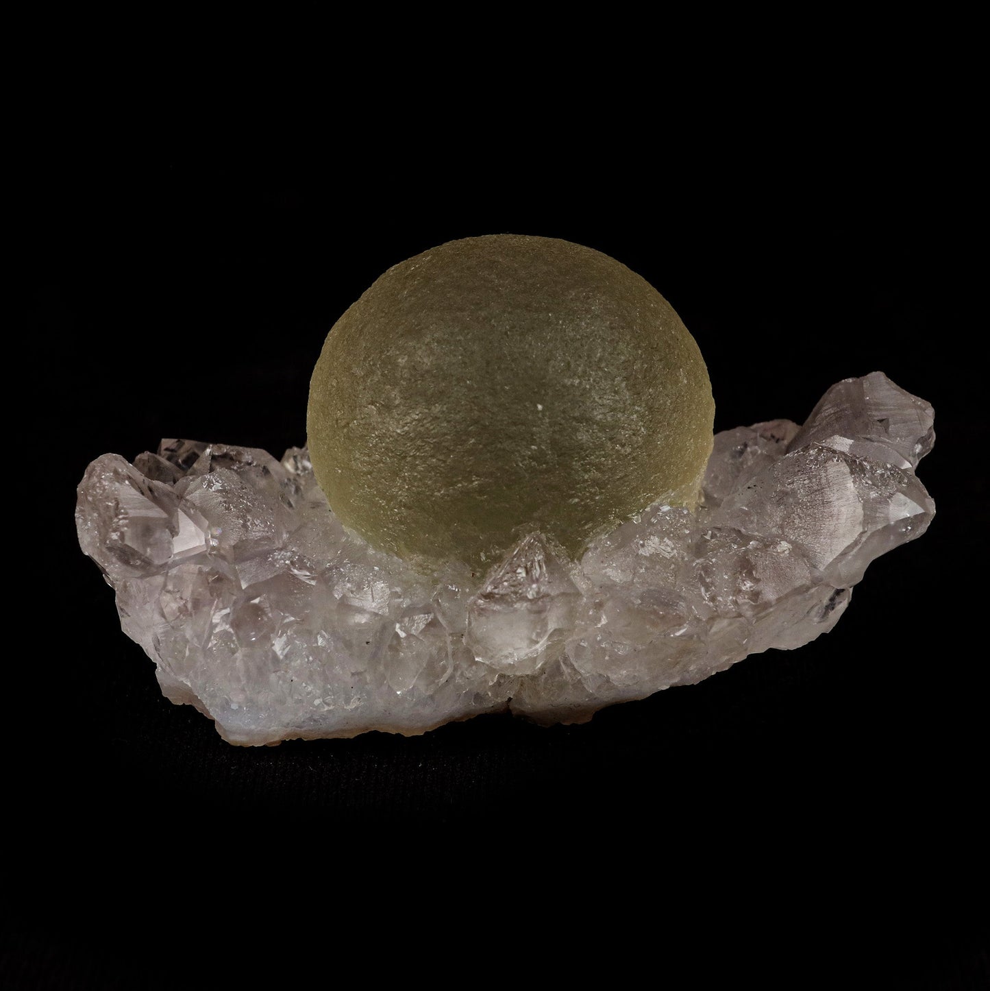 Fluorite Botridoal on MM Quartz Natural Mineral Specimen # B 5122 https://www.superbminerals.us/products/fluorite-botridoal-on-mm-quartz-natural-mineral-specimen-b-5122 Features: These golden botryoidal fluorites are unique and extremely attractive. This specimen features a a very gemmy, good sized, rich golden color, fluorite "sphere" on gemmy, colorless, stubby quartz crystal matrix. Primary Mineral(s): Fluorite Secondary Mineral(s): N/AMatrix: MM Quartz 2.5 Inch x 1.5 Inch