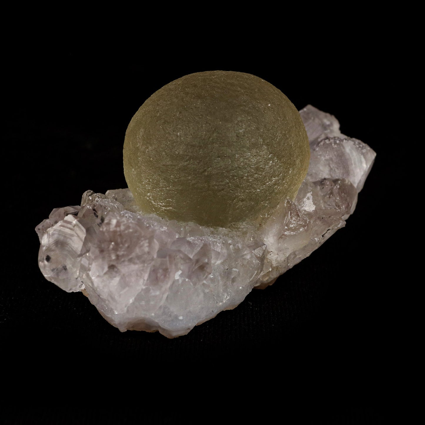 Fluorite Botridoal on MM Quartz Natural Mineral Specimen # B 5122 https://www.superbminerals.us/products/fluorite-botridoal-on-mm-quartz-natural-mineral-specimen-b-5122 Features: These golden botryoidal fluorites are unique and extremely attractive. This specimen features a a very gemmy, good sized, rich golden color, fluorite "sphere" on gemmy, colorless, stubby quartz crystal matrix. Primary Mineral(s): Fluorite Secondary Mineral(s): N/AMatrix: MM Quartz 2.5 Inch x 1.5 Inch