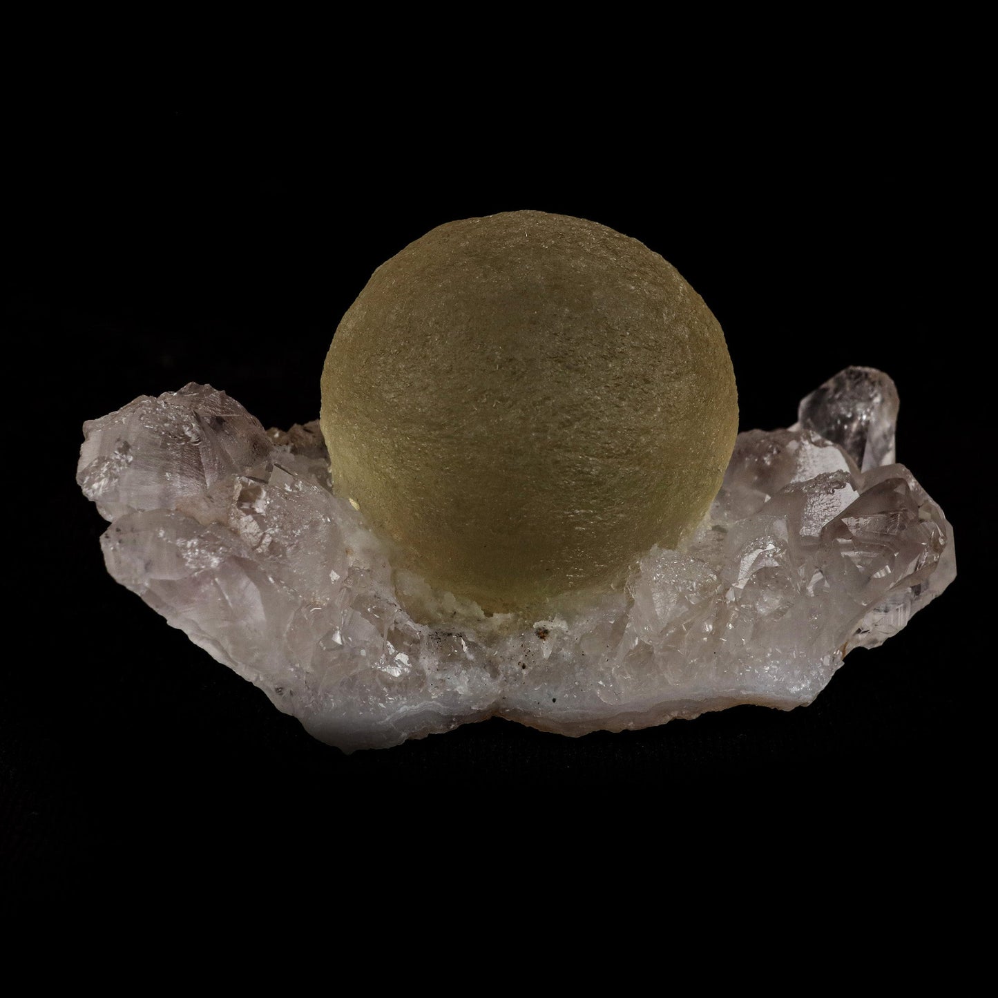 Fluorite Botridoal on MM Quartz Natural Mineral Specimen # B 5122 https://www.superbminerals.us/products/fluorite-botridoal-on-mm-quartz-natural-mineral-specimen-b-5122 Features: These golden botryoidal fluorites are unique and extremely attractive. This specimen features a a very gemmy, good sized, rich golden color, fluorite "sphere" on gemmy, colorless, stubby quartz crystal matrix. Primary Mineral(s): Fluorite Secondary Mineral(s): N/AMatrix: MM Quartz 2.5 Inch x 1.5 Inch