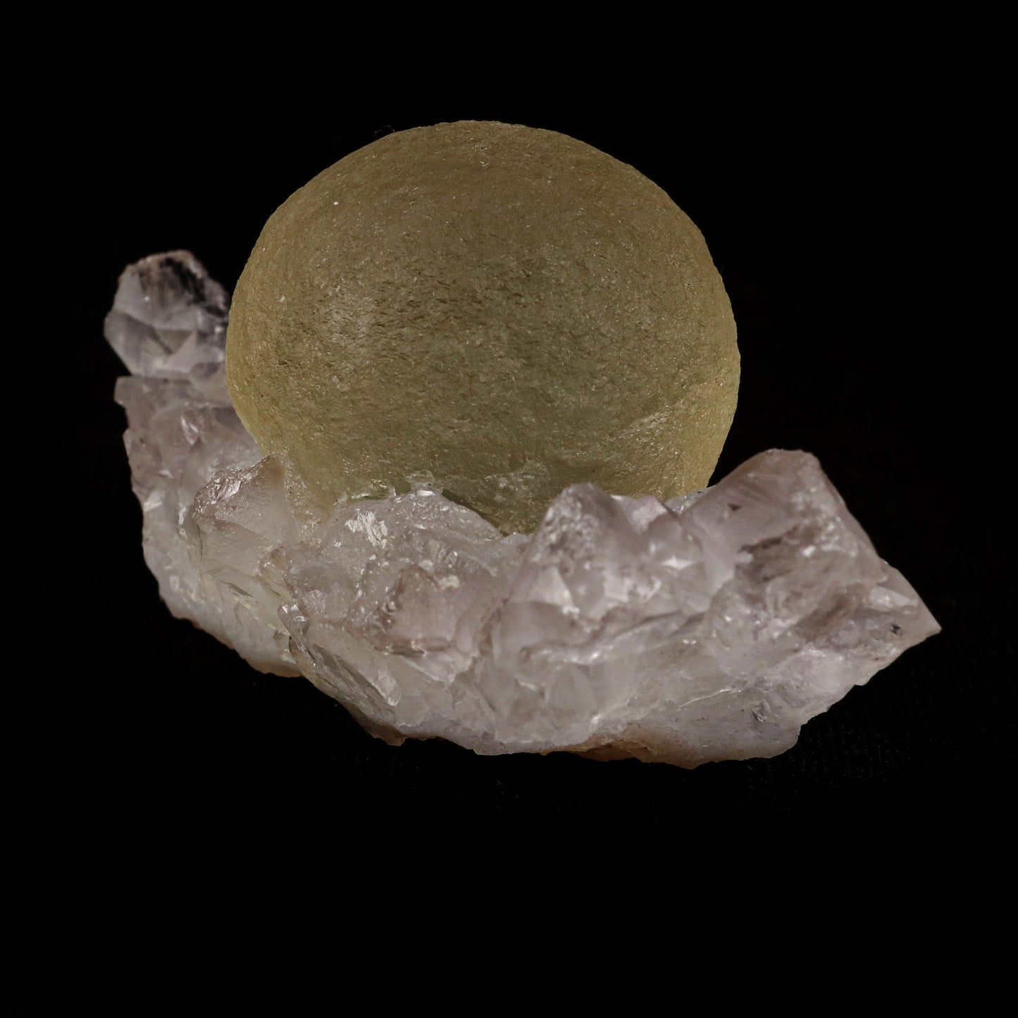 Fluorite Botridoal on MM Quartz Natural Mineral Specimen # B 5122 https://www.superbminerals.us/products/fluorite-botridoal-on-mm-quartz-natural-mineral-specimen-b-5122 Features: These golden botryoidal fluorites are unique and extremely attractive. This specimen features a a very gemmy, good sized, rich golden color, fluorite "sphere" on gemmy, colorless, stubby quartz crystal matrix. Primary Mineral(s): Fluorite Secondary Mineral(s): N/AMatrix: MM Quartz 2.5 Inch x 1.5 Inch
