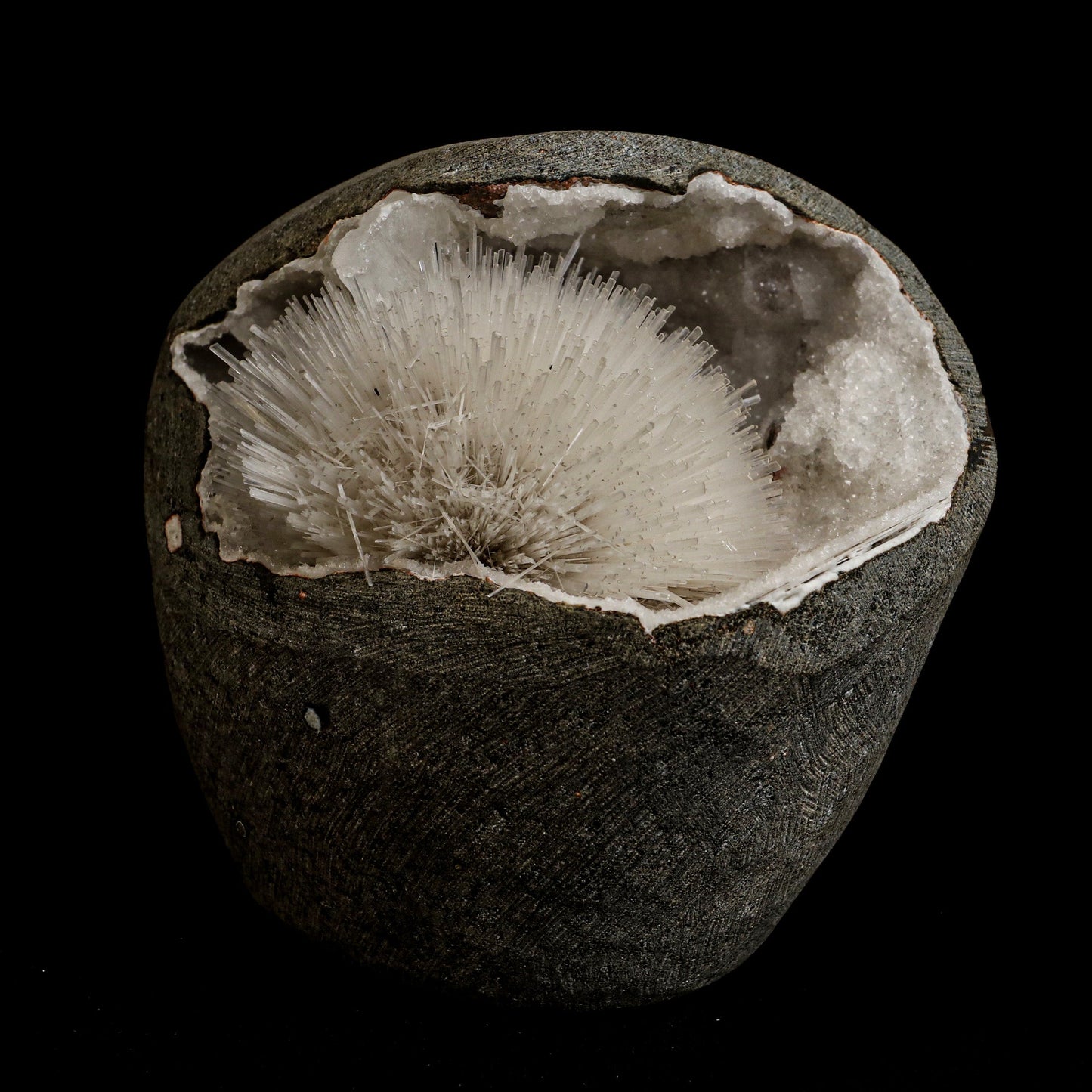 Mesolite Sphere Sprays Inside MM Quartz Geode Natural Mineral Specimen… https://www.superbminerals.us/products/mesolite-sphere-sprays-inside-mm-quartz-geode-natural-mineral-specimen-b-5063 Features: An impressive and very rich large hemispherical porcupine quill spray of glassy mesolite needles is aesthetically set inside geode of MM Quartz basalt matrix covered with contrasting frosted, tetragonal, mint-green apophyllite crystals on this very fine combination from the well-known quarries of the Pune