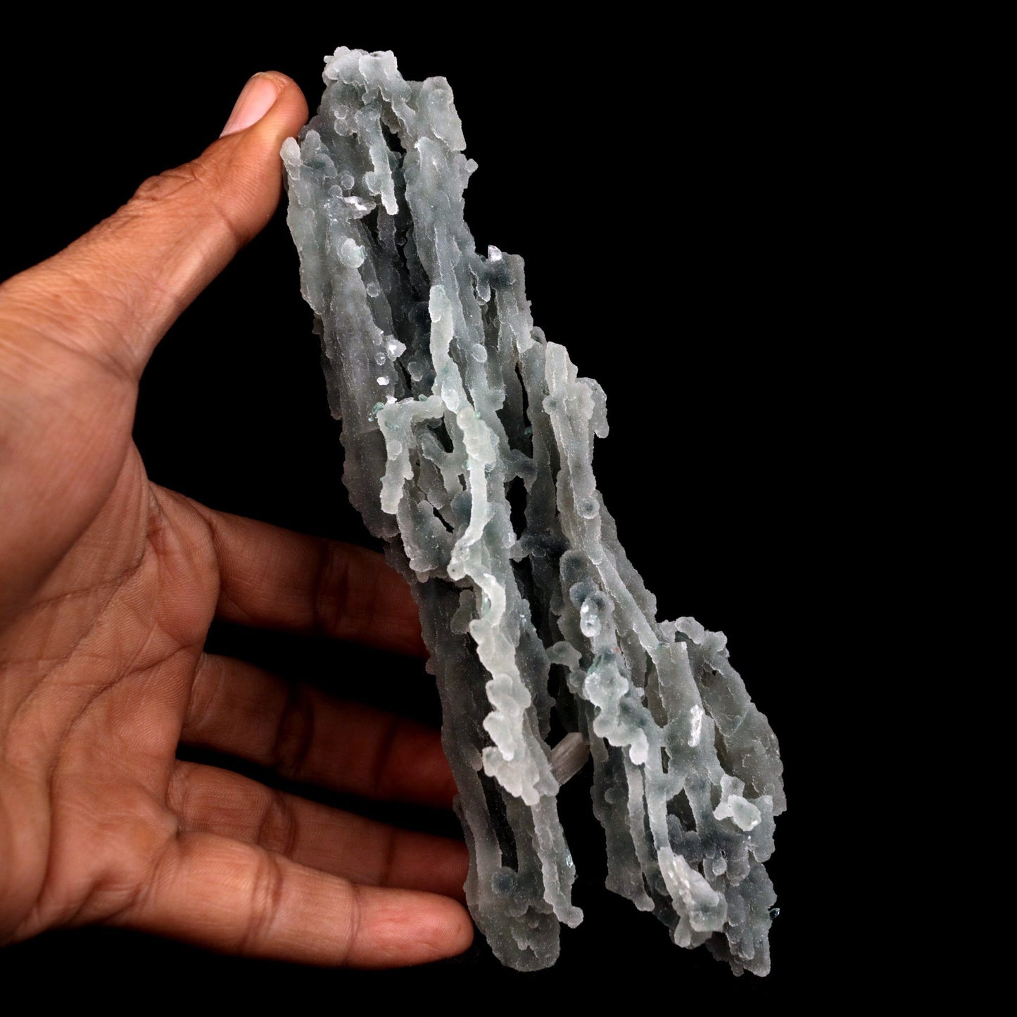 Stilbite on Chalcedony Coral Natural Mineral Specimen # B 4827 https://www.superbminerals.us/products/stilbite-on-chalcedony-coral-natural-mineral-specimen-b-4827 Features: Stalactites of drusy greenish-gray chalcedony dangle from a stunning corsage of iridescent, salmon-pink stilbite bowties. The matrix is highly sculptural.With only a few touched stalactite tips, this piece is essentially flawless and looks great from all angles!Outstanding huge Jalgaon combo