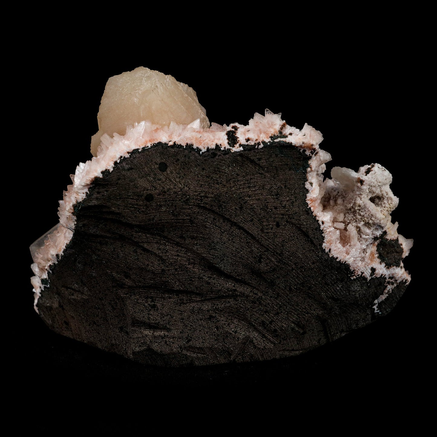 Stilbite on Heulanidte Natural Mineral Specimen # B 5154 https://www.superbminerals.us/products/stilbite-on-heulanidte-natural-mineral-specimen-b-5154 Features: This stilbite "bow tie" is beautiful, glossy, translucent, salmon pink.The shape and colour are stunning! As a species, it's quite common, and in classic bowtie shape, it's quite typical; a one-of-a-kind specimen for display purposes. Primary Mineral(s): Stilbite Secondary Mineral(s): N/AMatrix: Heulandite