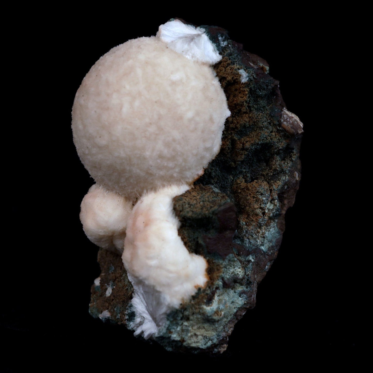 Thomsonite (Rare Pink) Balls Natural Mineral Specimen # B 4817 https://www.superbminerals.us/products/thomsonite-rare-pink-balls-natural-mineral-specimen-b-4817 Features: This is an excellent show specimen with lovely semi-velvety radiating spheres of Thomsonite over minor green and brown contrasting basalt. The piece's best feature is that it is not the usual white hue observed in Thomsonite, but rather a unique and exquisite rose PINK colour on the surface,