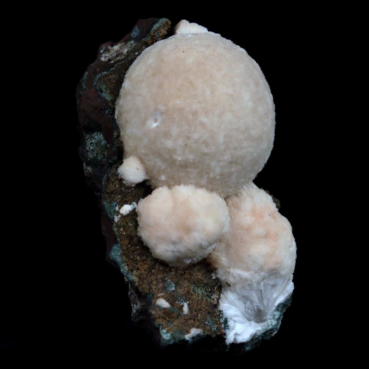 Thomsonite (Rare Pink) Balls Natural Mineral Specimen # B 4817  https://www.superbminerals.us/products/thomsonite-rare-pink-balls-natural-mineral-specimen-b-4817  Features: This is an excellent show specimen with lovely semi-velvety radiating spheres of Thomsonite over minor green and brown contrasting basalt. The piece's best feature is that it is not the usual white hue observed in Thomsonite, but rather a unique and exquisite rose PINK colour on the surface,