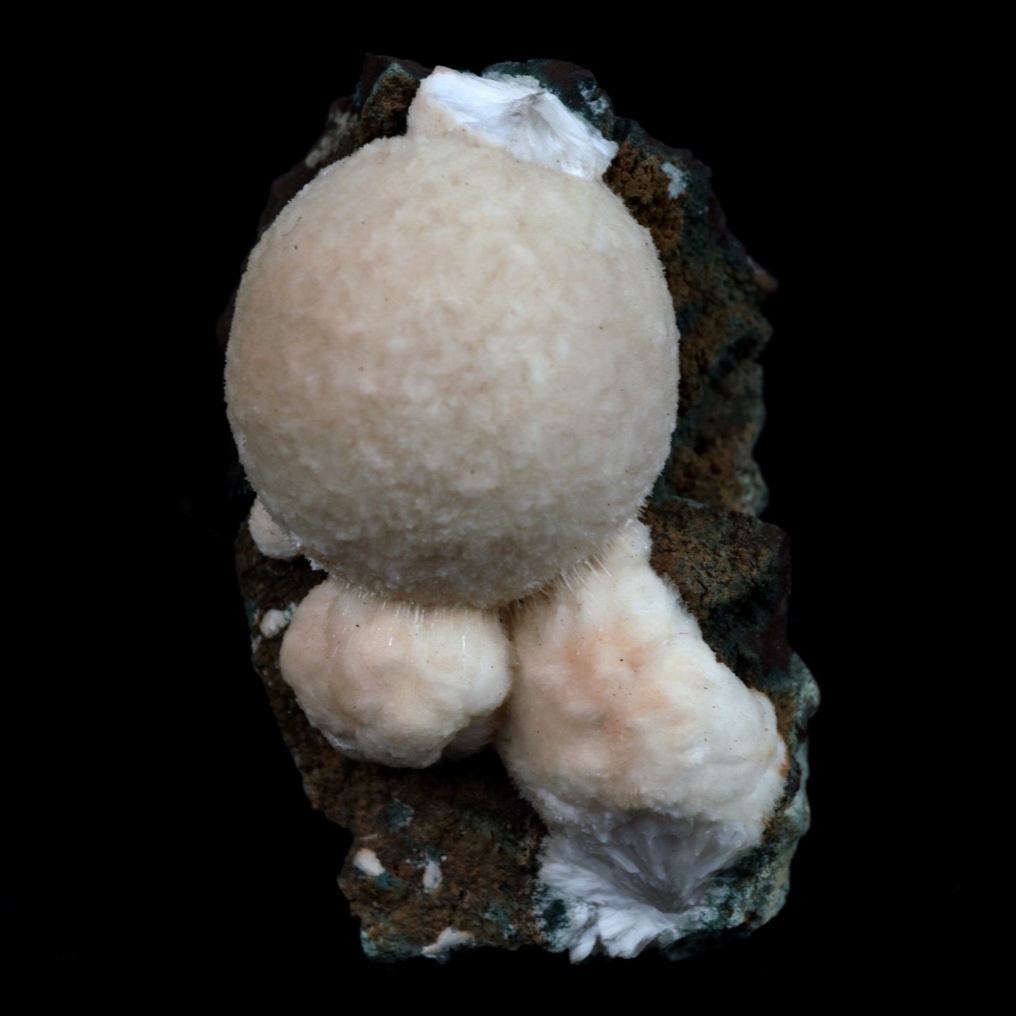 Thomsonite (Rare Pink) Balls Natural Mineral Specimen # B 4817 https://www.superbminerals.us/products/thomsonite-rare-pink-balls-natural-mineral-specimen-b-4817 Features: This is an excellent show specimen with lovely semi-velvety radiating spheres of Thomsonite over minor green and brown contrasting basalt. The piece's best feature is that it is not the usual white hue observed in Thomsonite, but rather a unique and exquisite rose PINK colour on the surface,