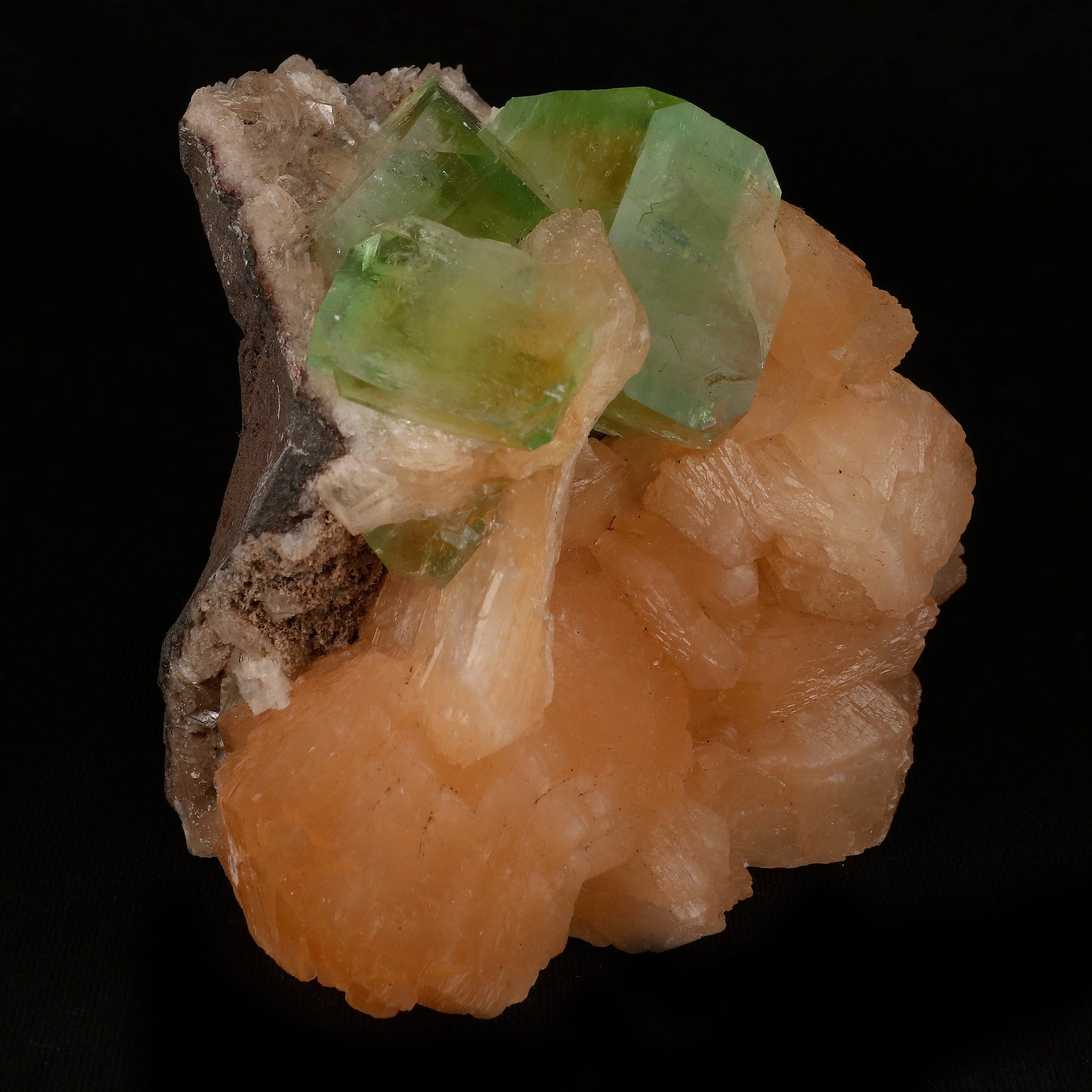 Bi-colored Fluorapophyllite and Stilbite Natural Mineral Specimen # B…  https://www.superbminerals.us/products/green-apophyllite-cubic-crystal-with-stilbite-natural-mineral-specimen-b-5077  Features: A striking, large blocky, color-zoned apophyllite crystal aesthetically flanked by similar smaller crystals dramatically highlights this impressive large mounded combination from recent finds in Jalgaon. The glassy, translucent tetragonal apophyllites have rich mint-green centers and colorless terminations 