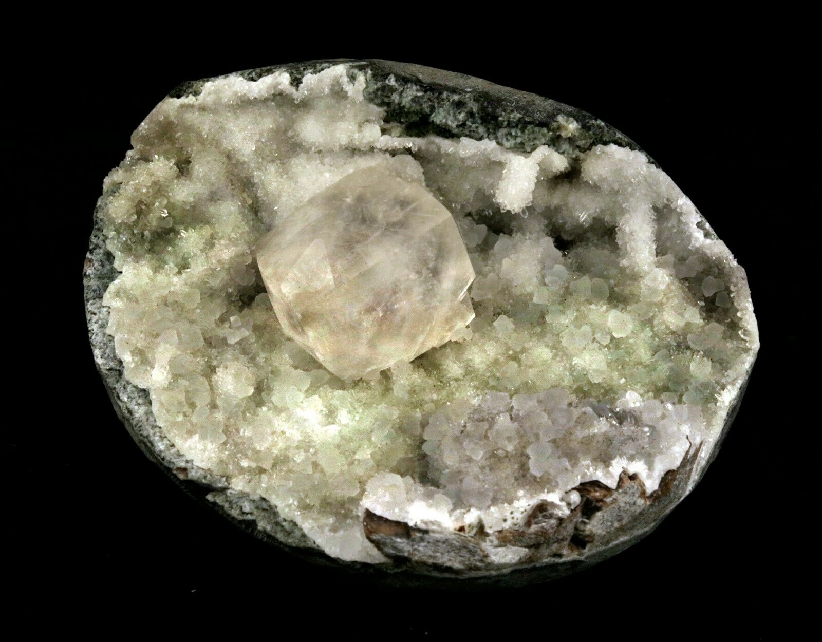 Calcite Cube inside MM Quartz Geode Natural Minerals Specimen # B 2490  https://www.superbminerals.us/products/calcite-cube-inside-mm-quartz-geode-natural-minerals-specimen-b-2490  Features: This is a superb piece that features an exceptionally large Geode lined with lustrous, colorless microcrystalline MM Quartz and MM Quartz hosting one large, translucent Calcite cube. The cube is flawless the result of being protected within a Geode and are perfectly positioned to give the piece outstanding
