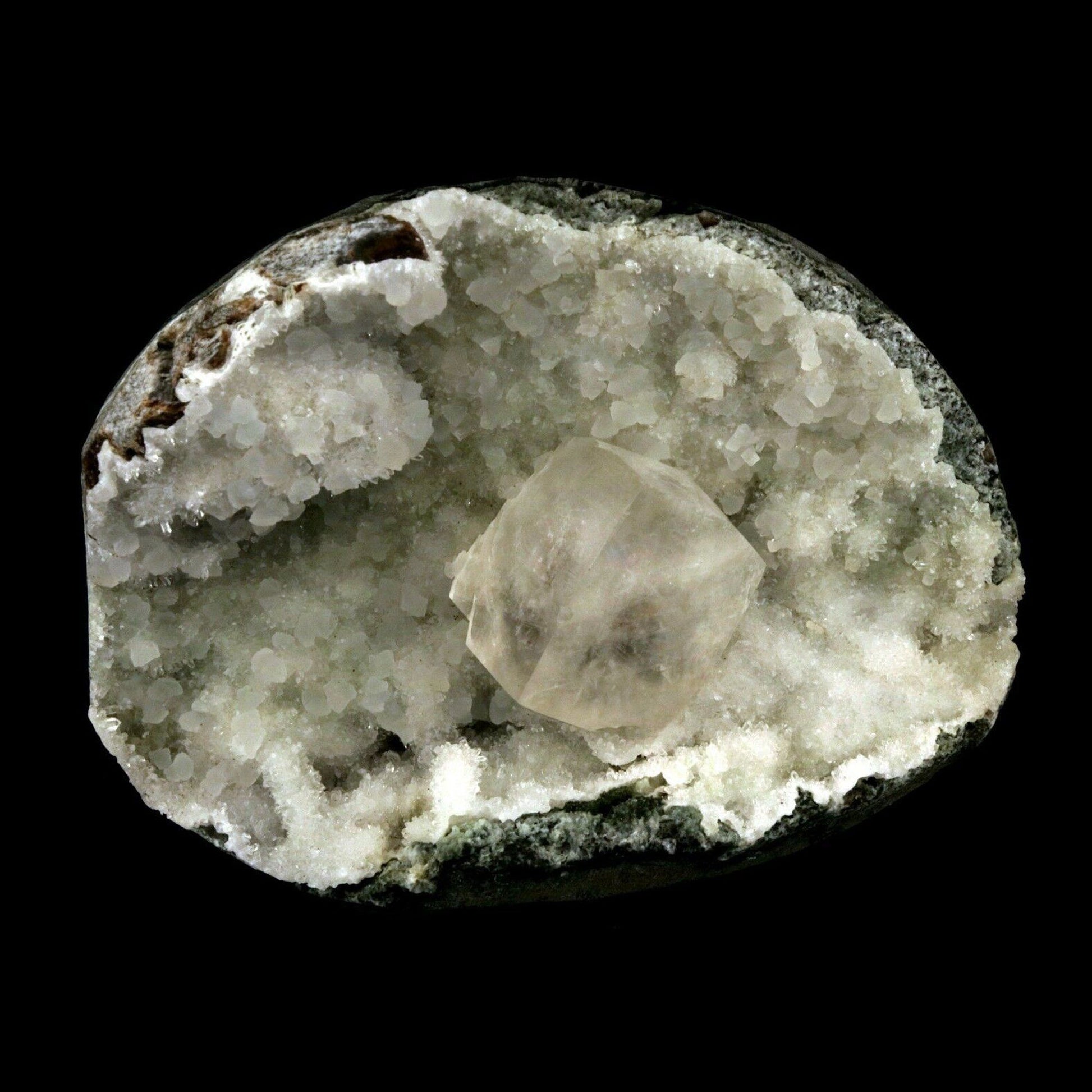 Calcite Cube inside MM Quartz Geode Natural Minerals Specimen # B 2490  https://www.superbminerals.us/products/calcite-cube-inside-mm-quartz-geode-natural-minerals-specimen-b-2490  Features: This is a superb piece that features an exceptionally large Geode lined with lustrous, colorless microcrystalline MM Quartz and MM Quartz hosting one large, translucent Calcite cube. The cube is flawless the result of being protected within a Geode and are perfectly positioned to give the piece outstanding