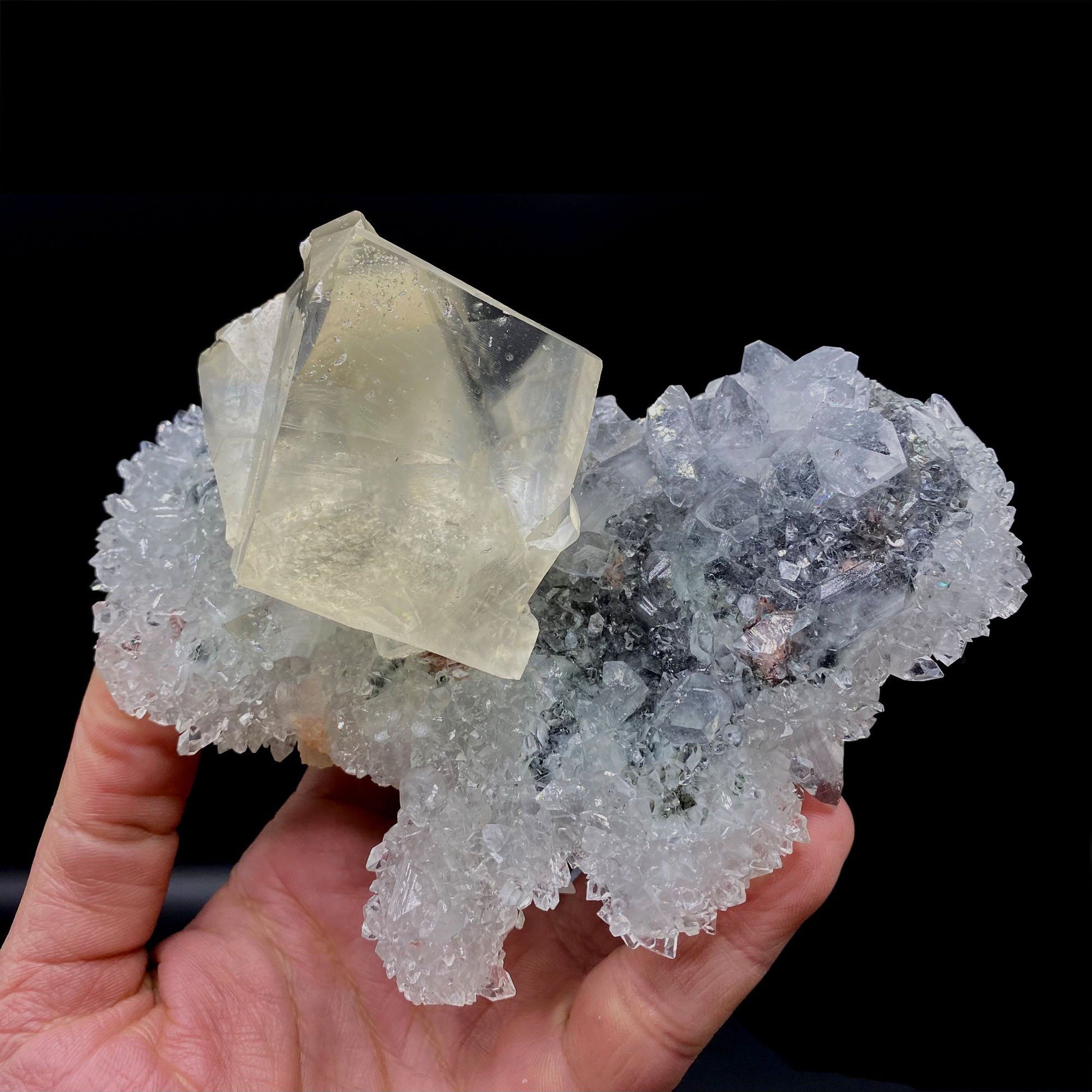 Calcite with Apophyllite on Heuladnite # Q9  https://www.superbminerals.us/products/calcite-with-apophyllite-on-heuladnite-q9  Features:Fascinating specimen of Calcite and impressive mirror lustrous gemmy Apophyllite crystals from superb find in Jalgaon. It displays twin honey colored Calcite Cube, well formed superb flat faces with excellent brilliance and light reflection.&nbsp; Lustrous Calcite crystals grow at the top forming aesthetic