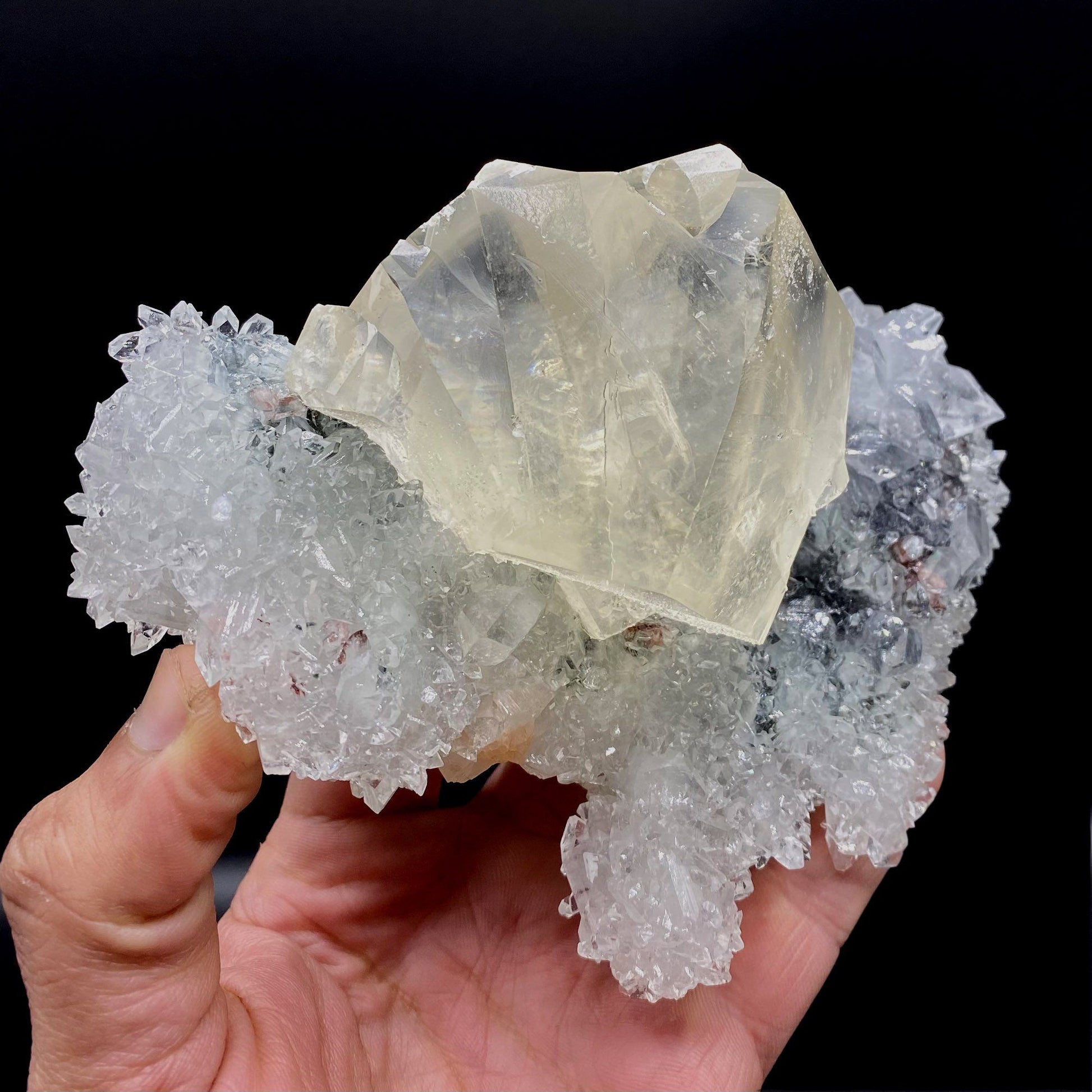 Calcite with Apophyllite on Heuladnite # Q9  https://www.superbminerals.us/products/calcite-with-apophyllite-on-heuladnite-q9  Features:Fascinating specimen of Calcite and impressive mirror lustrous gemmy Apophyllite crystals from superb find in Jalgaon. It displays twin honey colored Calcite Cube, well formed superb flat faces with excellent brilliance and light reflection.&nbsp; Lustrous Calcite crystals grow at the top forming aesthetic