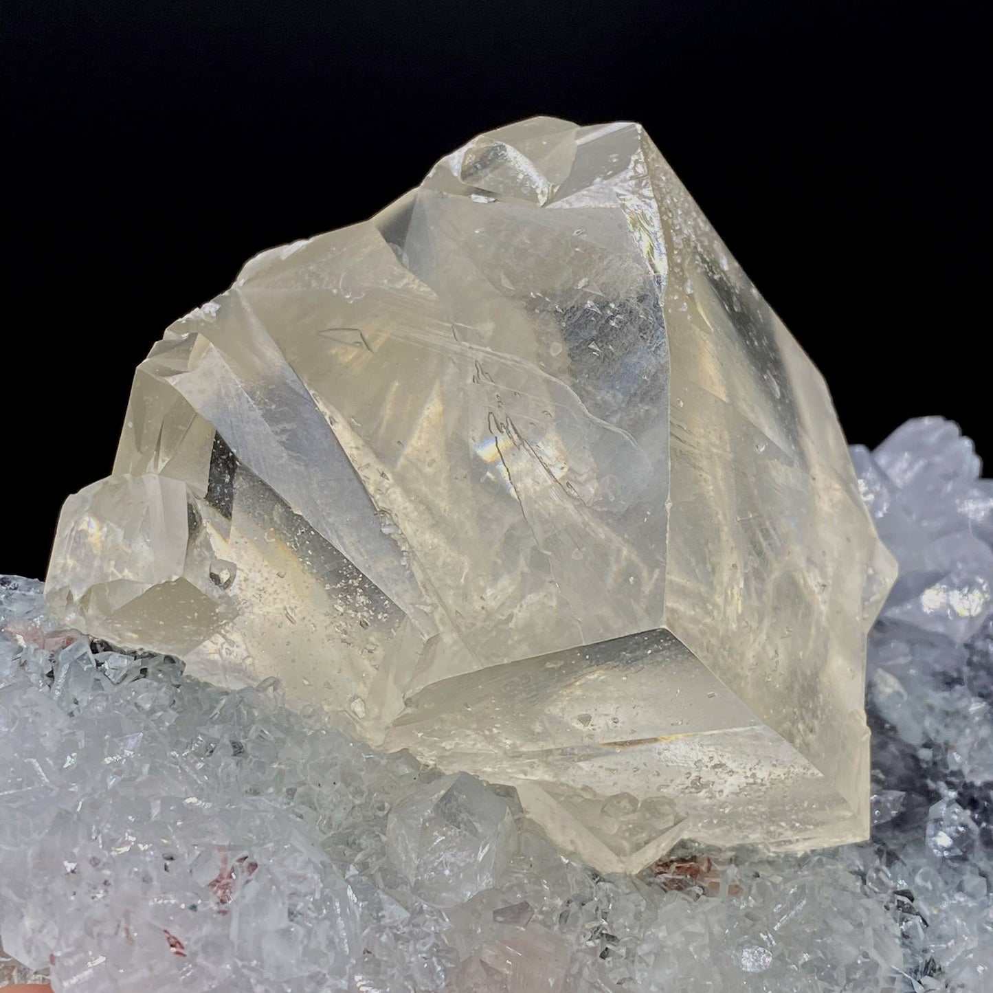 Calcite with Apophyllite on Heuladnite # Q9  https://www.superbminerals.us/products/calcite-with-apophyllite-on-heuladnite-q9  Features:Fascinating specimen of Calcite and impressive mirror lustrous gemmy Apophyllite crystals from superb find in Jalgaon. It displays twin honey colored Calcite Cube, well formed superb flat faces with excellent brilliance and light reflection.&nbsp; Lustrous Calcite crystals grow at the top forming aesthetic