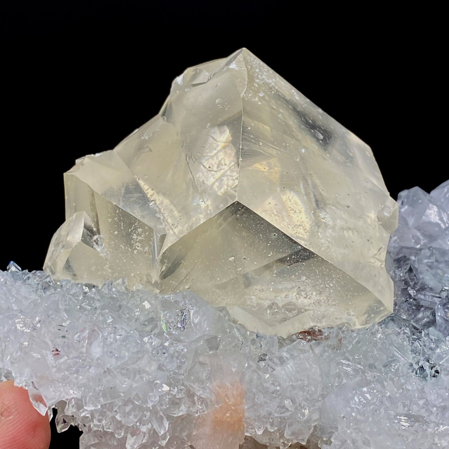 Calcite with Apophyllite on Heuladnite # Q9  https://www.superbminerals.us/products/calcite-with-apophyllite-on-heuladnite-q9  Features:Fascinating specimen of Calcite and impressive mirror lustrous gemmy Apophyllite crystals from superb find in Jalgaon. It displays twin honey colored Calcite Cube, well formed superb flat faces with excellent brilliance and light reflection.&nbsp; Lustrous Calcite crystals grow at the top forming aesthetic