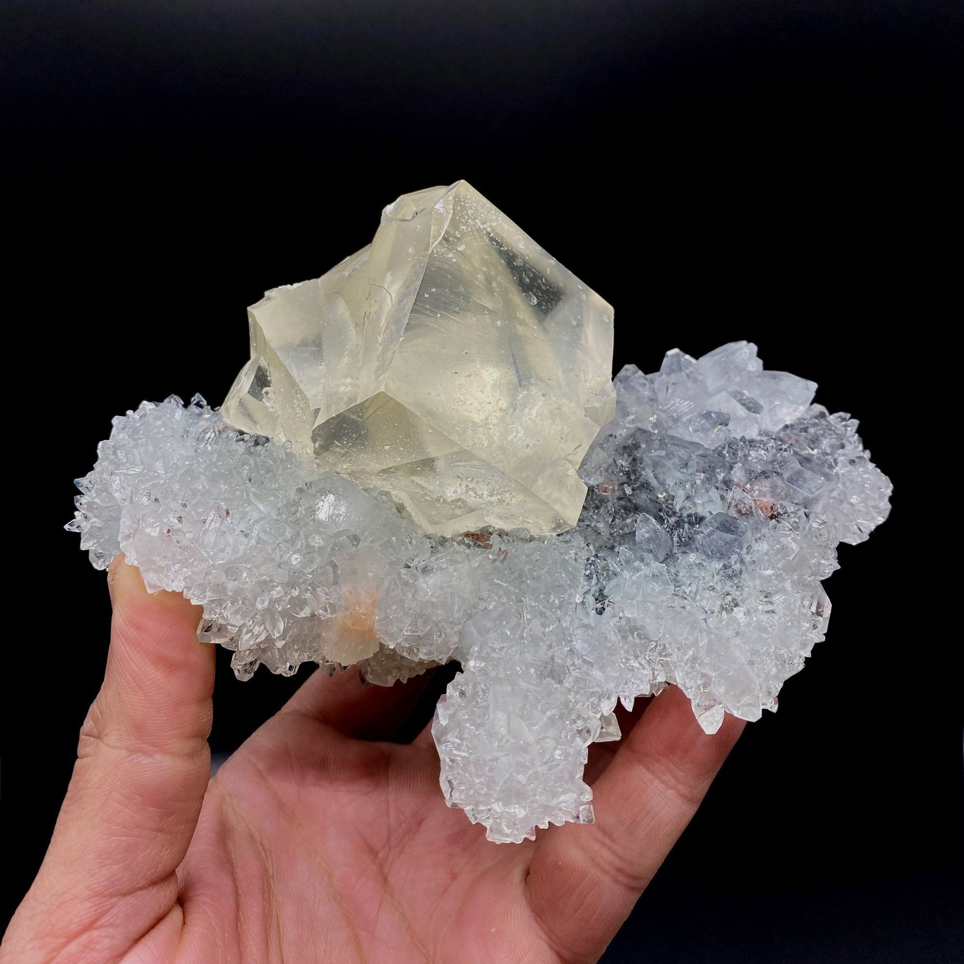 Calcite with Apophyllite on Heuladnite # Q9  https://www.superbminerals.us/products/calcite-with-apophyllite-on-heuladnite-q9  Features:Fascinating specimen of Calcite and impressive mirror lustrous gemmy Apophyllite crystals from superb find in Jalgaon. It displays twin honey colored Calcite Cube, well formed superb flat faces with excellent brilliance and light reflection.&nbsp; Lustrous Calcite crystals grow at the top forming aesthetic