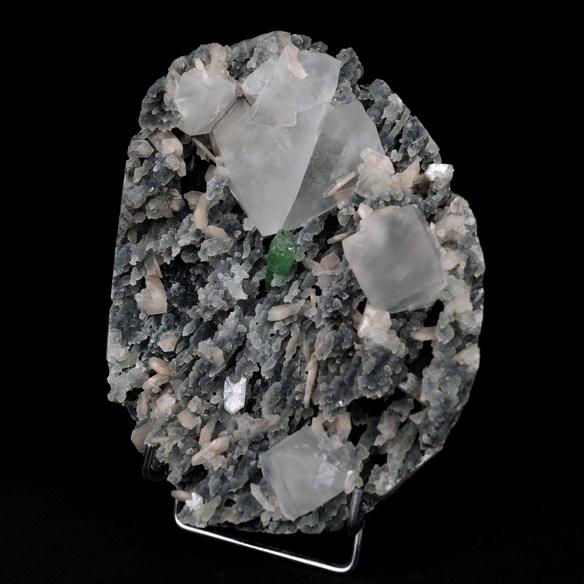 Calcite with Green Apophyllite with Stilbite (Excellent) Vug # B 4228  https://www.superbminerals.us/products/calcite-with-green-apophyllite-with-stilbite-excellent-vug-b-4228  Features:An exceptionally sculptural and impressive large combination zeolite specimen from Aurangabad. The very well prepared deep triangular vug in basalt matrix is lined with sparkly, bubbly, drusy gray chalcedony. The striking and aesthetic mound in the middle hosts pearlescent, flesh-pink, stilbite crystals,