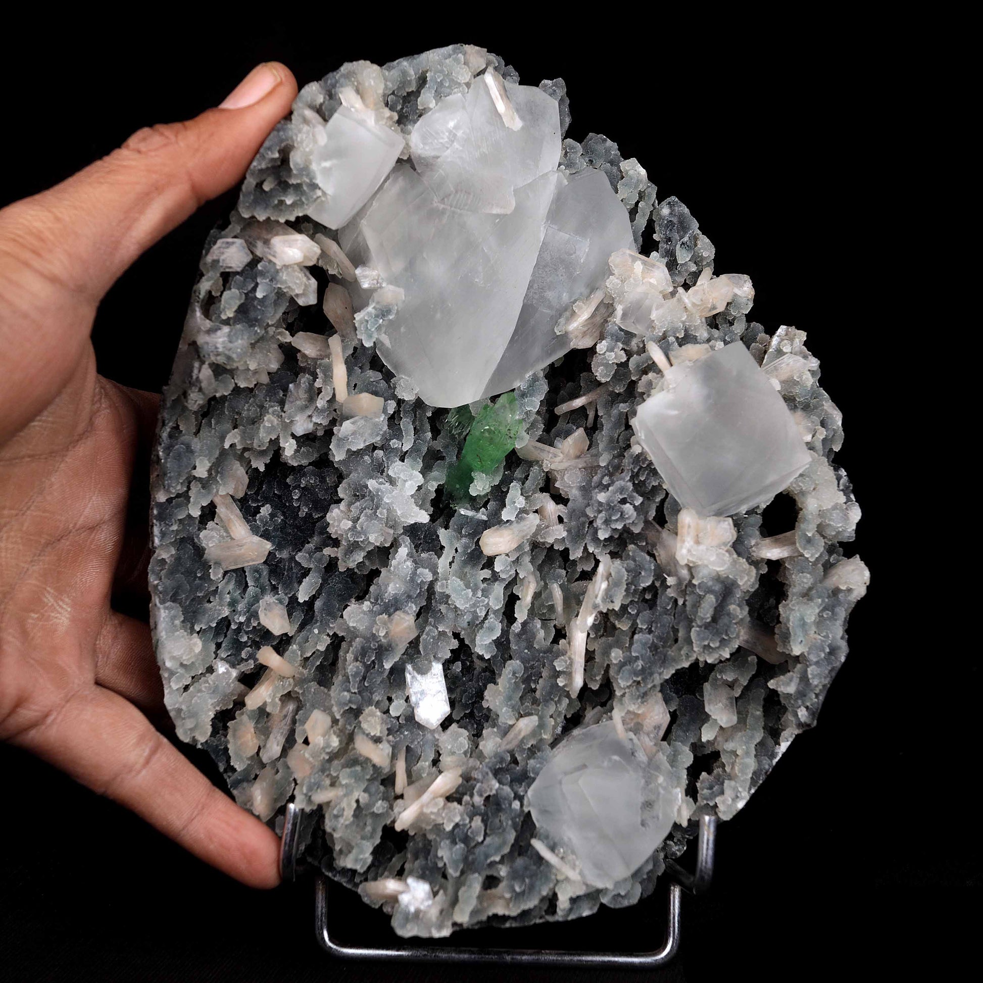 Calcite with Green Apophyllite with Stilbite (Excellent) Vug # B 4228  https://www.superbminerals.us/products/calcite-with-green-apophyllite-with-stilbite-excellent-vug-b-4228  Features:An exceptionally sculptural and impressive large combination zeolite specimen from Aurangabad. The very well prepared deep triangular vug in basalt matrix is lined with sparkly, bubbly, drusy gray chalcedony. The striking and aesthetic mound in the middle hosts pearlescent, flesh-pink, stilbite crystals,