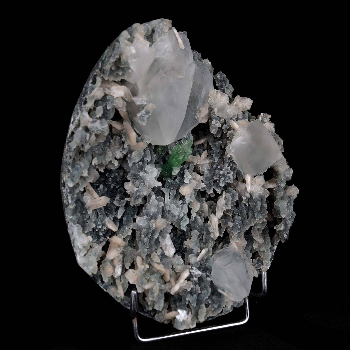 Calcite with Green Apophyllite with Stilbite (Excellent) Vug # B 4228  https://www.superbminerals.us/products/calcite-with-green-apophyllite-with-stilbite-excellent-vug-b-4228  Features:An exceptionally sculptural and impressive large combination zeolite specimen from Aurangabad. The very well prepared deep triangular vug in basalt matrix is lined with sparkly, bubbly, drusy gray chalcedony. The striking and aesthetic mound in the middle hosts pearlescent, flesh-pink, stilbite crystals,