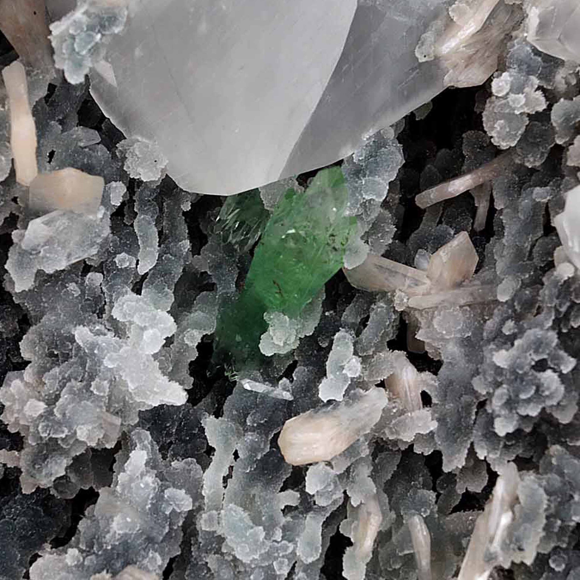 Calcite with Green Apophyllite with Stilbite (Excellent) Vug # B 4228  https://www.superbminerals.us/products/calcite-with-green-apophyllite-with-stilbite-excellent-vug-b-4228  Features:An exceptionally sculptural and impressive large combination zeolite specimen from Aurangabad. The very well prepared deep triangular vug in basalt matrix is lined with sparkly, bubbly, drusy gray chalcedony. The striking and aesthetic mound in the middle hosts pearlescent, flesh-pink, stilbite crystals,