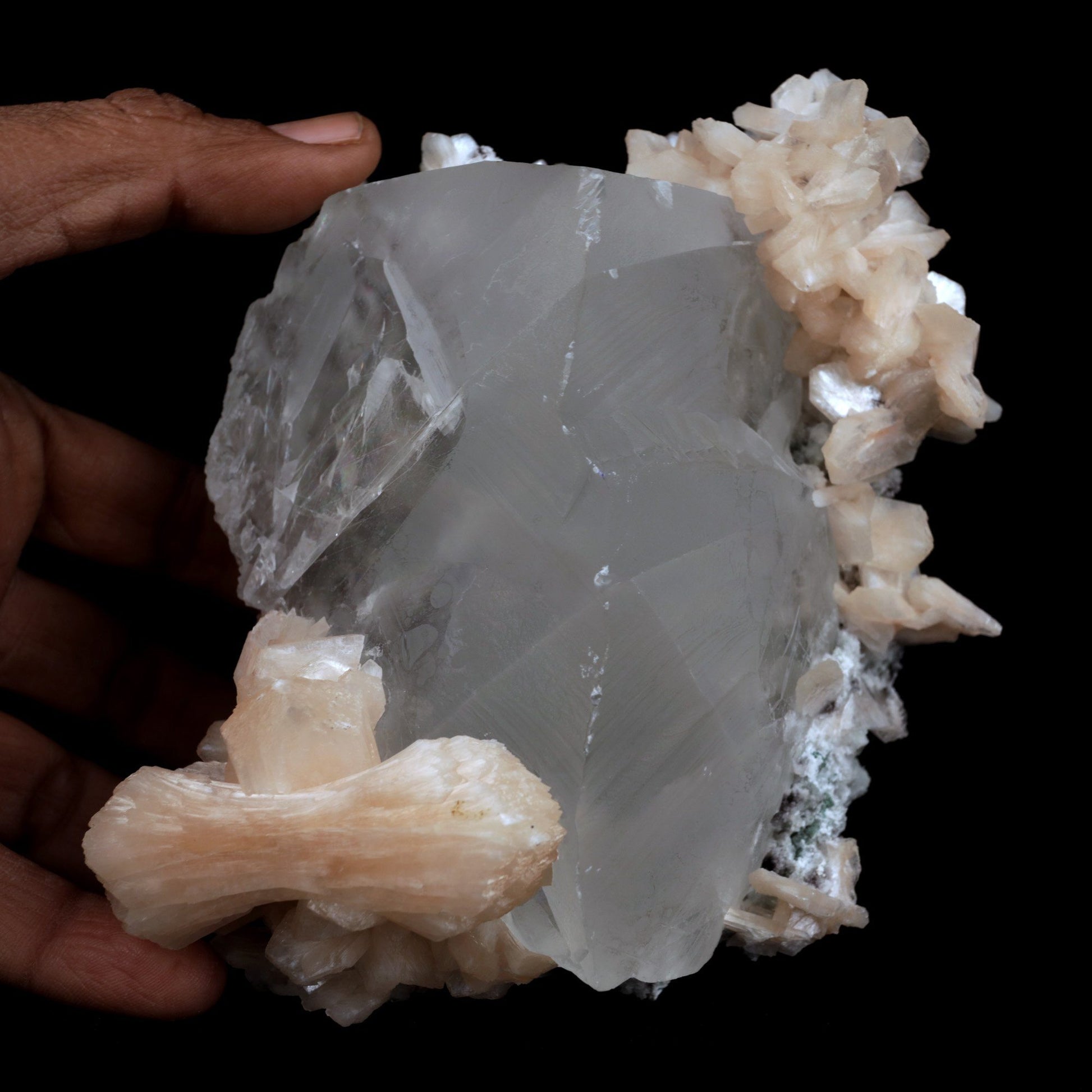 Calcite with Stilbite Natural Mineral Specimen (Repaired) # B 3904  https://www.superbminerals.us/products/calcite-with-stilbite-natural-mineral-specimen-repaired-b-3904  FeaturesA huge, delightful smooth white to smoky rhombohedral Calcite crystal, anxious, with crossing Stilbite crystals on a network of snow-white microcrystalline Quartz, with minor Apophyllite. 