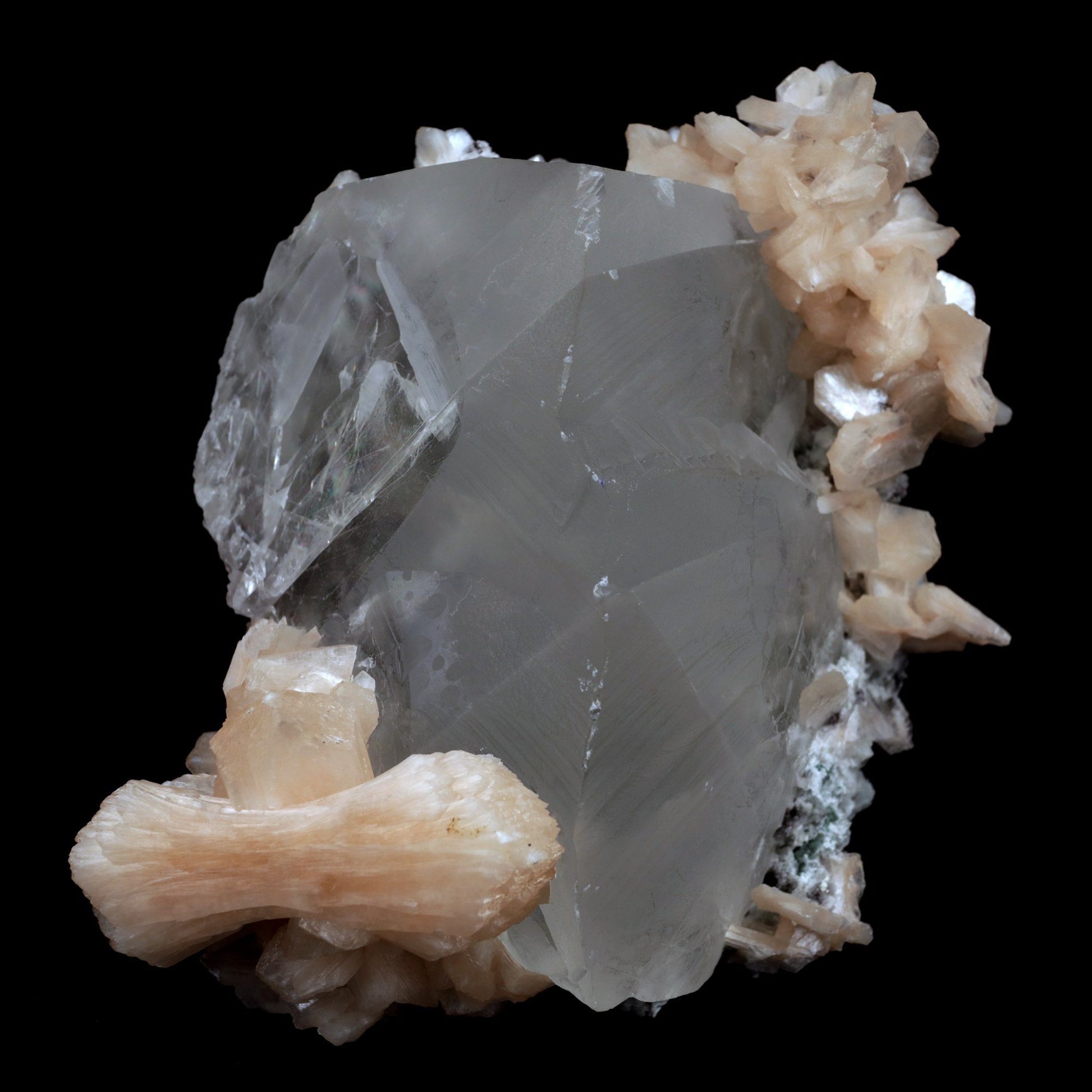 Calcite with Stilbite Natural Mineral Specimen (Repaired) # B 3904  https://www.superbminerals.us/products/calcite-with-stilbite-natural-mineral-specimen-repaired-b-3904  FeaturesA huge, delightful smooth white to smoky rhombohedral Calcite crystal, anxious, with crossing Stilbite crystals on a network of snow-white microcrystalline Quartz, with minor Apophyllite. 