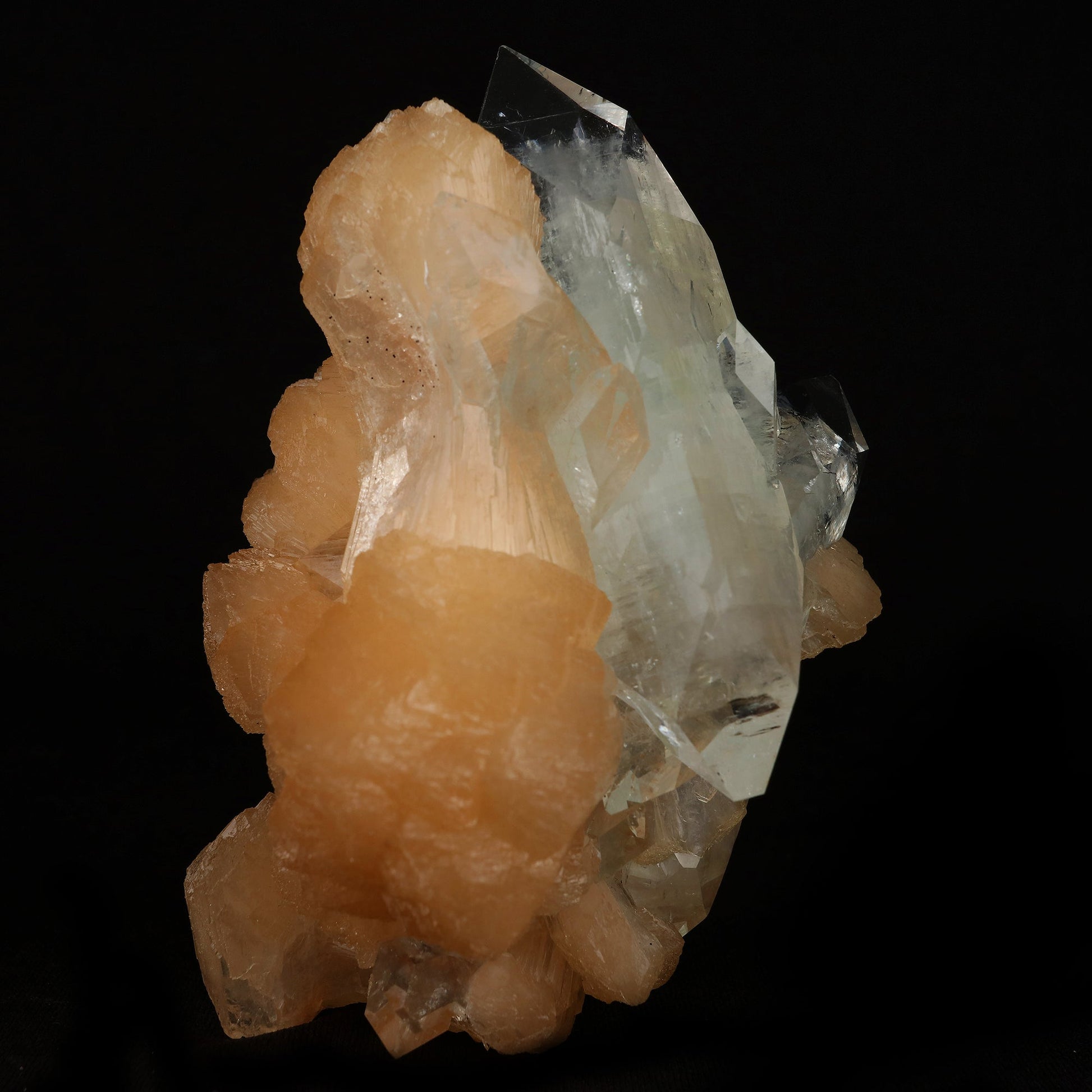 Clear Apophyllite With Stilbite Natural Mineral Specimen # B 5079  https://www.superbminerals.us/products/clear-apophyllite-with-stilbite-natural-mineral-specimen-b-5079  Features: Highlighted by a highly lustrous and partially gemmy, colorless fluorapophyllite crystal, this specimen also exhibits lustrous and translucent, pink stilbite crystals, to 2.8 cm in length. This specimen is a superb, sparkling combo piece! It is complete alla round and looks like a sparkling tower. 