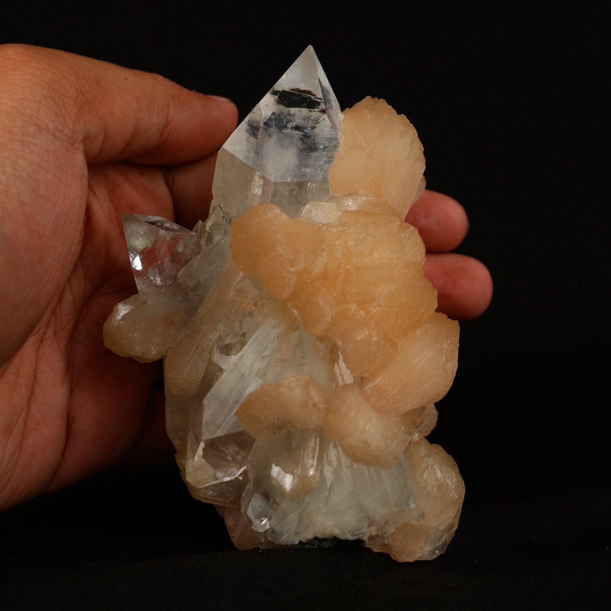 Clear Apophyllite With Stilbite Natural Mineral Specimen # B 5079  https://www.superbminerals.us/products/clear-apophyllite-with-stilbite-natural-mineral-specimen-b-5079  Features: Highlighted by a highly lustrous and partially gemmy, colorless fluorapophyllite crystal, this specimen also exhibits lustrous and translucent, pink stilbite crystals, to 2.8 cm in length. This specimen is a superb, sparkling combo piece! It is complete alla round and looks like a sparkling tower. 