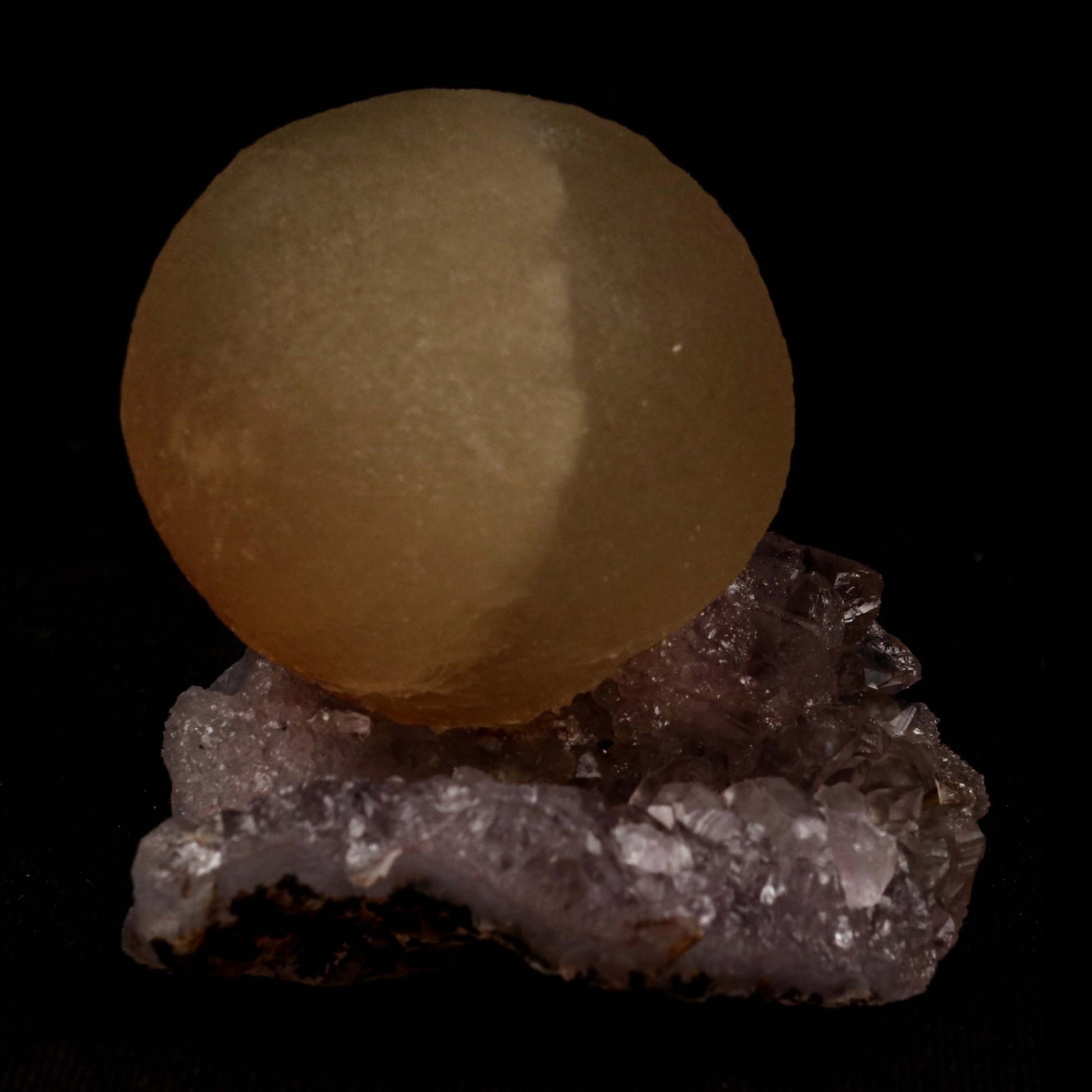 Fluorite Botridoal on Amethyst Natural Mineral Specimen # B 5194  https://www.superbminerals.us/products/fluorite-botridoal-on-amethyst-natural-mineral-specimen-b-5194  Features: An extremely botryoidal "ball" of Fluorite perches above an incredibly rich purple-colored Amethyst on Chalcedony and host rock matrix, resulting in an unusually stunning specimen. The Fluorite is a creamy-white tone on the surface that gradually fades away to a golden tint in the centre.