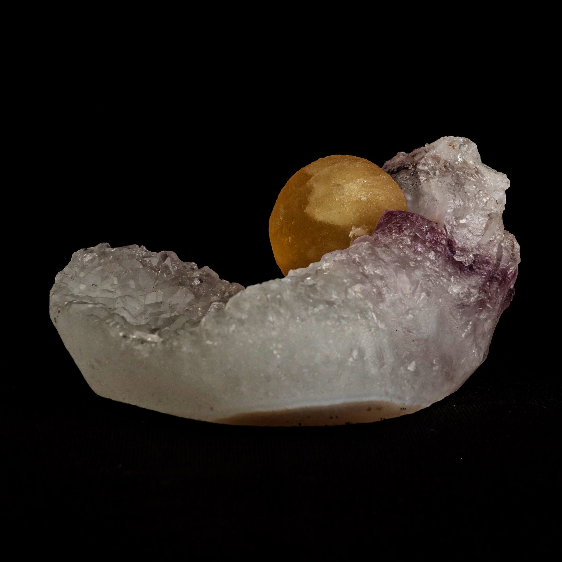 Fluorite Botryoidal on Amethyst Natural Mineral Specimen # B 5058  https://www.superbminerals.us/products/fluorite-botryoidal-on-amethyst-natural-mineral-specimen-b-5058  Features: An extraordinarily botryoidal "ball" of Fluorite is perched atop an exceptionally rich purple coloured Amethyst on Chalcedony and host rock matrix, creating an unusually beautiful specimen.&nbsp; On the surface, the Fluorite is a creamy-white tone that gradually fades away to a golden hue in the middle.
