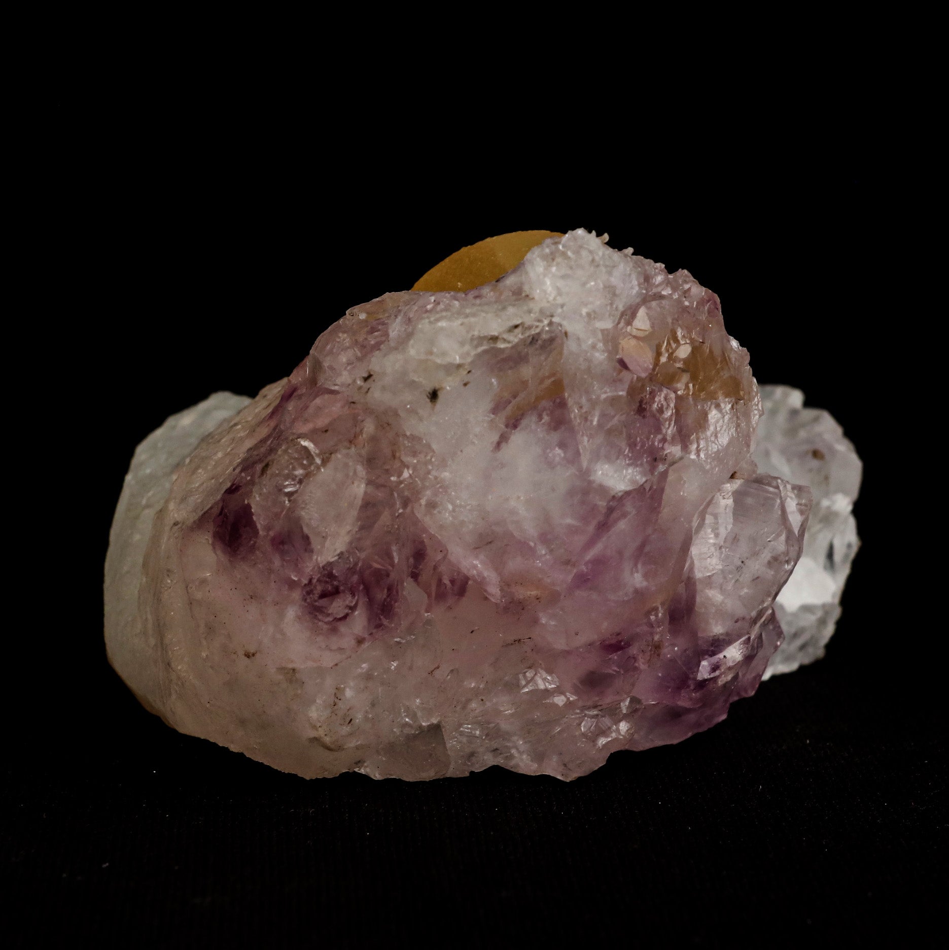 Fluorite Botryoidal on Amethyst Natural Mineral Specimen # B 5058  https://www.superbminerals.us/products/fluorite-botryoidal-on-amethyst-natural-mineral-specimen-b-5058  Features: An extraordinarily botryoidal "ball" of Fluorite is perched atop an exceptionally rich purple coloured Amethyst on Chalcedony and host rock matrix, creating an unusually beautiful specimen.&nbsp; On the surface, the Fluorite is a creamy-white tone that gradually fades away to a golden hue in the middle.