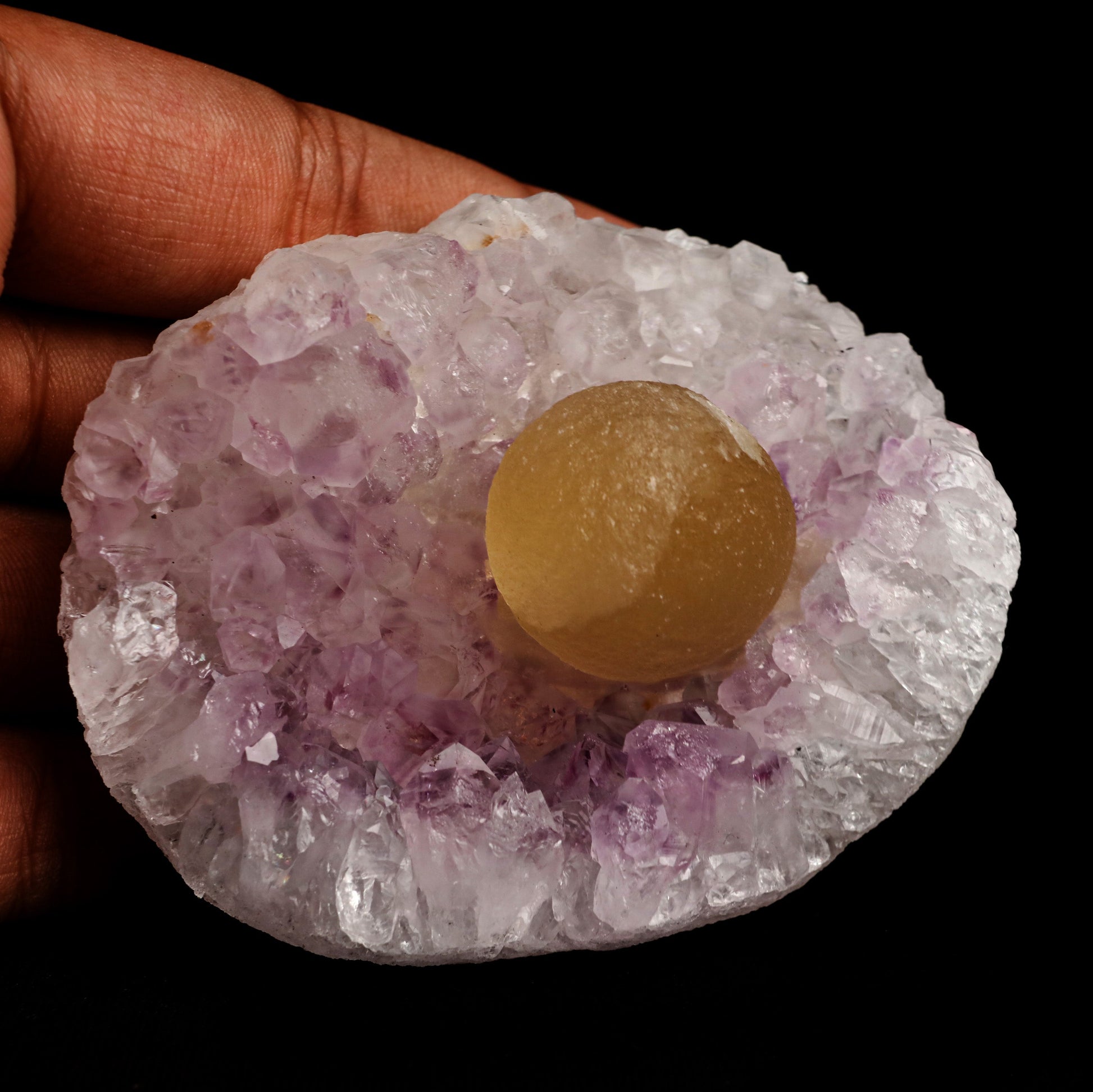Fluorite Botryoidal Shaded on Amethyst Natural Mineral Specimen # B 5…  https://www.superbminerals.us/products/fluorite-botryoidal-shaded-on-amethyst-natural-mineral-specimen-b-5067  Features: A prominent botryoidal "ball" of Fluorite perches on light purple coloured Amethyst and soft lilac coloured Chalcedony matrix in this specimen. The Fluorite has a gorgeous golden tone throughout, and when the "ball" is lighted, the colour GLOWS. A supplementary Fluorite sphere at a lesser size 