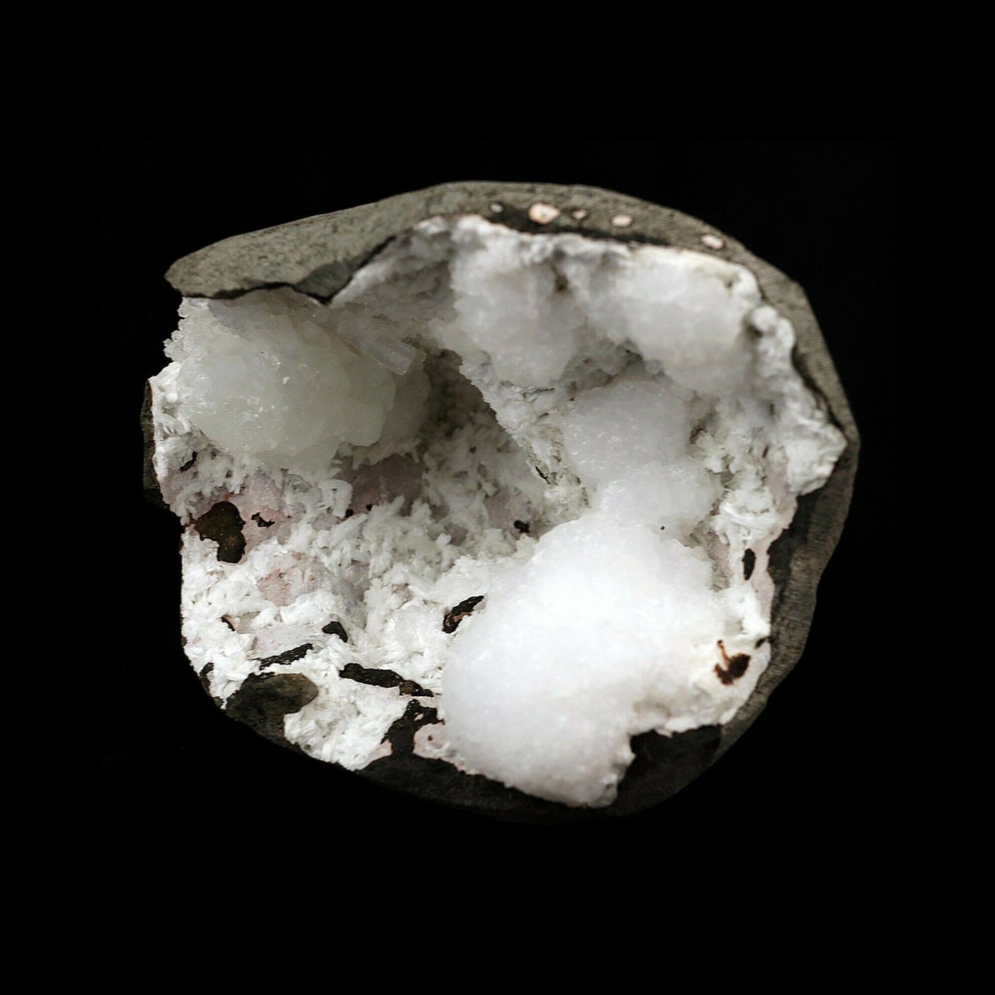Goosecreekite Rare Mineral in Semi Geod Natural Mineral Specimen # B3612  https://www.superbminerals.us/products/goosecreekite-rare-mineral-in-semi-geod-natural-mineral-specimen-b-3612  Features:Very fine specimen of the very rare zeolite mineral goosecreekite. The goosecreekite has grown in a translucent white nodular formation of goosecreekite in polycrystalline aggregates,The crystals on this beauty are sharp with white coloring and vitreous luster. The goosecreekite sits inside a basalt geode