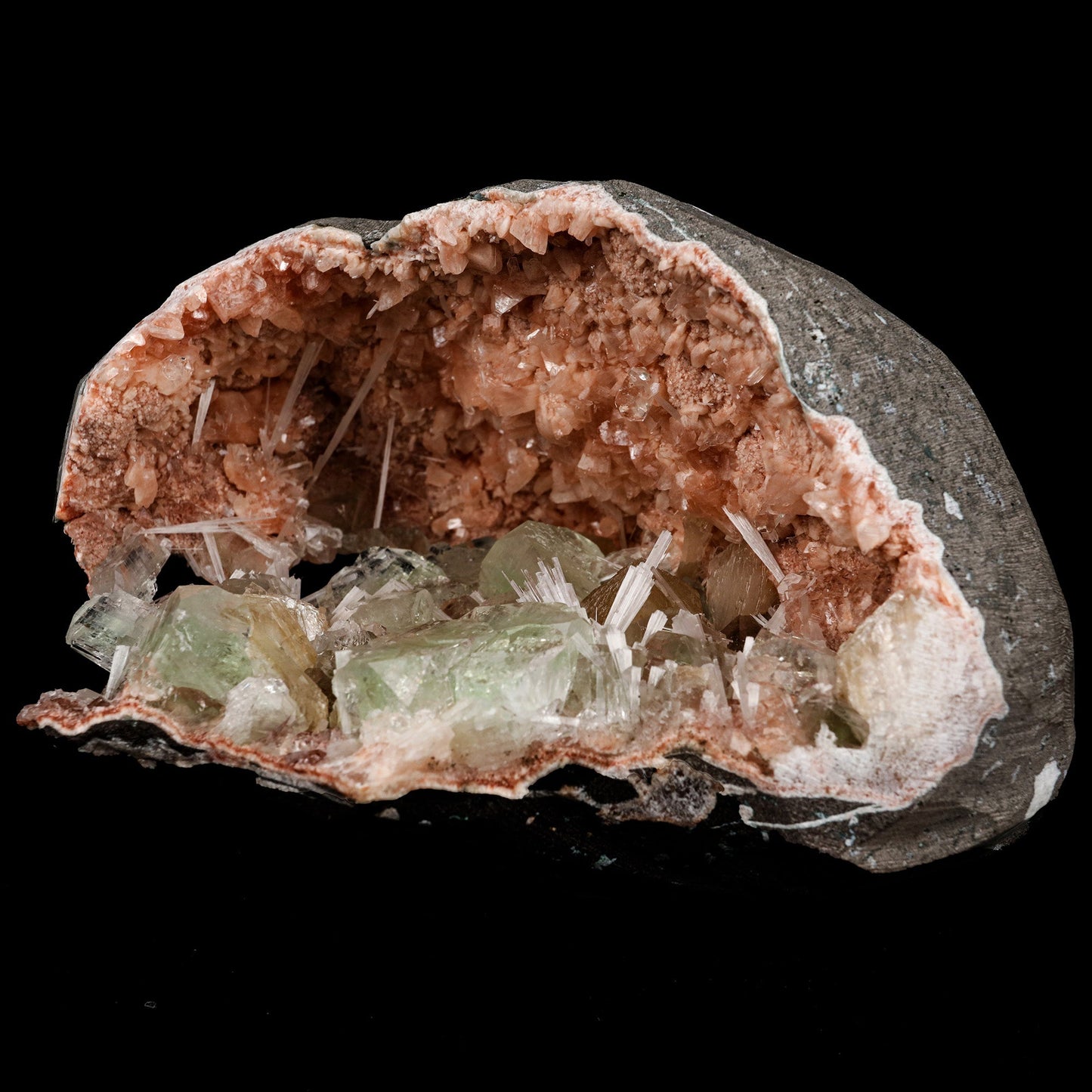 Green Apophyllite Crystals Inside Heulandite Geode Natural Mineral Spe…  https://www.superbminerals.us/products/green-apophyllite-crystals-inside-heulandite-geode-natural-mineral-specimen-b-5254  Features: This beautiful display specimen is a feast of color, texture, and reflections of light. Apophyllite crystals have a high luster on their sides, which contrasts beautifully with their flat, pearl-like terminations. Several acicular sprays of colorless to white, satin and Scolecite. Through the Apophyllite