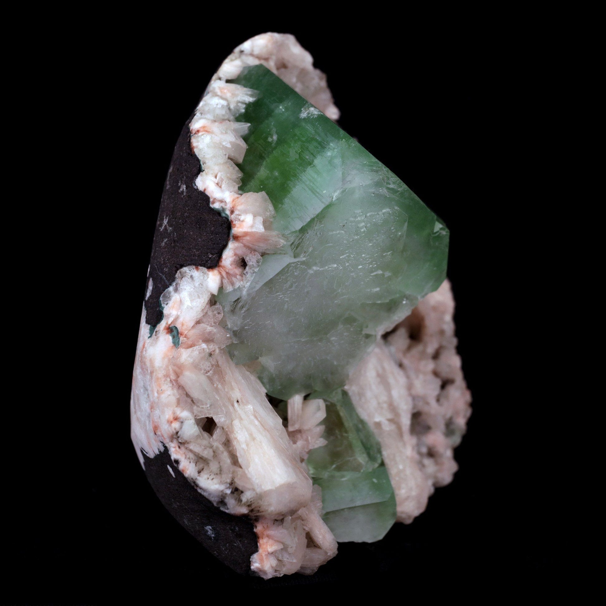 Green Apophyllite Cube with Stilbite Heulandite Natural Mineral # B 41…  https://www.superbminerals.us/products/green-apophyllite-cube-with-stilbite-heulandite-natural-mineral-b-4161  Features:Large shallow vug with a transparent penetrating layerd dark green to mint green Apophyllite cubic crystal on druzy chalcedony formations with Stilbite crystals, all on a bed of white miniature Huelandite crystals on a dark gray Matrix. The color of the Apophyllite is exceptional as is the contrast 