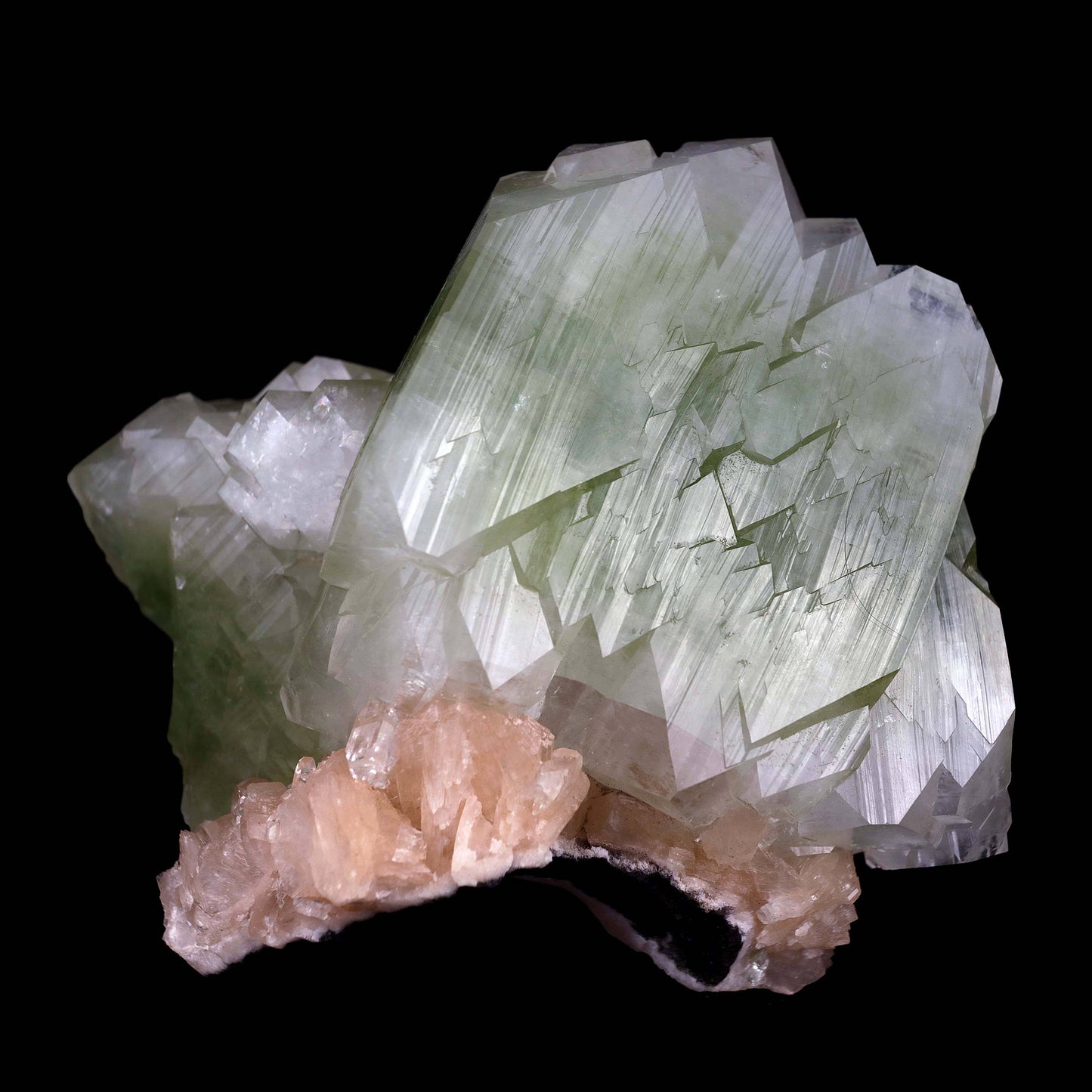 Green Apophyllite Cube with Stilbite Natural Mineral Specimen # B 448…  https://www.superbminerals.us/products/green-apophyllite-cube-with-stilbite-natural-mineral-specimen-b-4482  Features:This is a very fine, big, doubly terminated, glossy and translucent bicolored green fluorapophyllite crystal that has been tastefully set on a matrix of aged basalt and quartz druse. A few beautiful, ivory-colored stilbite crystals encircle the base. 