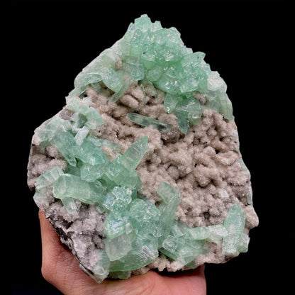 Green Apophyllite Sparkling Crystals on Heulandite Cluster # Q2  https://www.superbminerals.us/products/green-apophyllite-sparkling-crystals-on-heulandite-cluster-q2  Features:Sparkling cluster of green Apophyllite crystals in a radiating formation on matrix lined with creme-colored stilbite crystals in aggregates. The apophyllite crystals are fully terminated with vivd green color and glassy luster.&nbsp;Primary Mineral(s): ApophylliteSecondary Mineral(s): N/A Matrix: Heulandite
