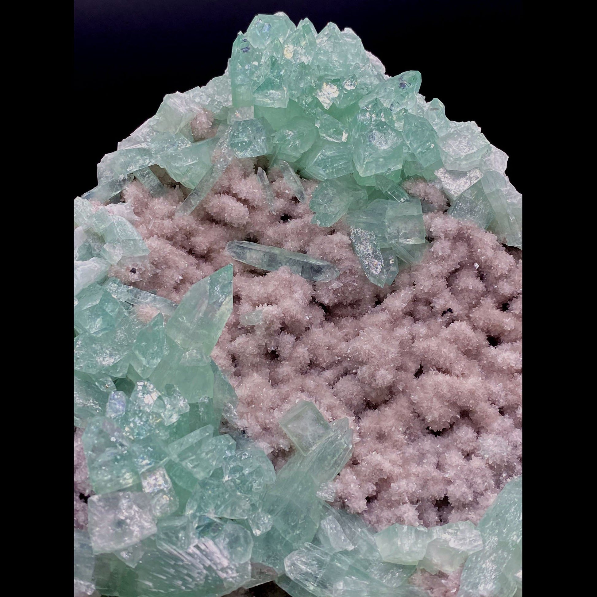 Green Apophyllite Sparkling Crystals on Heulandite Cluster # Q2  https://www.superbminerals.us/products/green-apophyllite-sparkling-crystals-on-heulandite-cluster-q2  Features:Sparkling cluster of green Apophyllite crystals in a radiating formation on matrix lined with creme-colored stilbite crystals in aggregates. The apophyllite crystals are fully terminated with vivd green color and glassy luster.&nbsp;Primary Mineral(s): ApophylliteSecondary Mineral(s): N/A Matrix: Heulandite