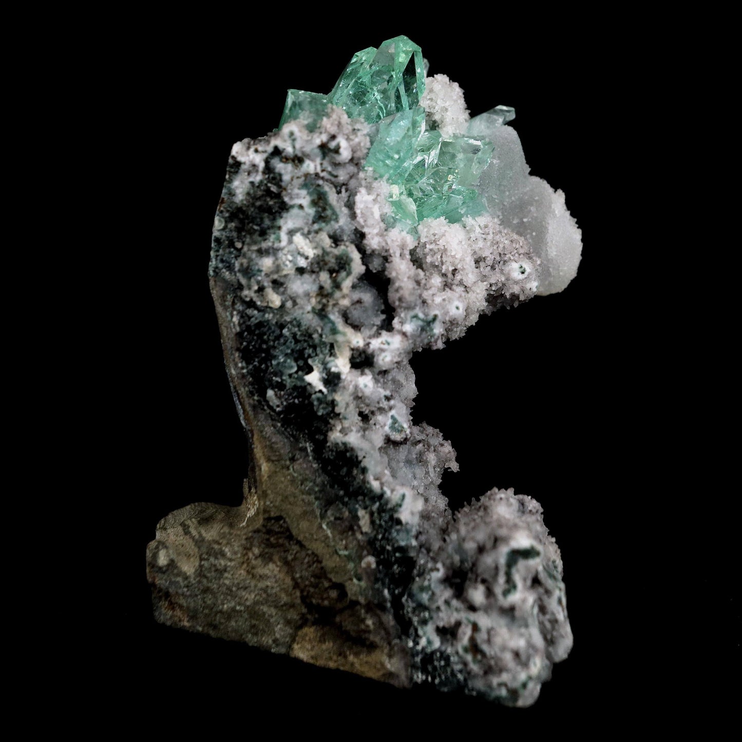 Green Apophyllite with Coated Calcite on Black Chalcedony Natural Mine…  https://www.superbminerals.us/products/green-apophyllite-with-coated-calcite-on-black-chalcedony-natural-mineral-specimen-b-4600  Features:An exceptionally sculptural and impressive large combination zeolite specimen from Aurangabad. The very well prepared deep triangular vug in basalt matrix is lined with sparkly, bubbly, drusy gray chalcedony. The striking and aesthetic mound in the middle hosts pearlescent