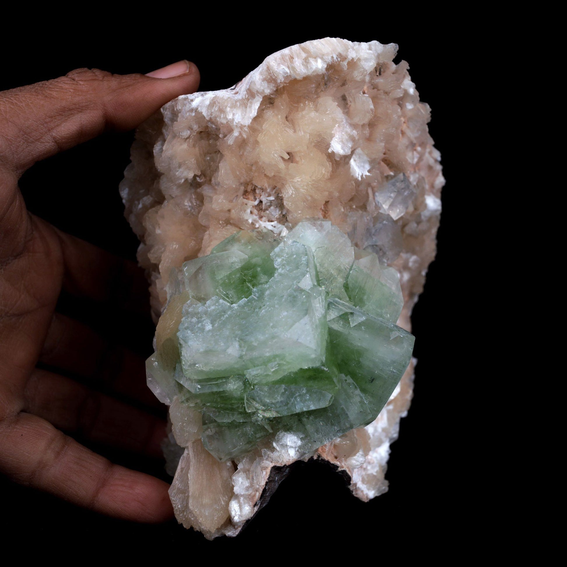 Green Apophyllite With Stilbite Natural Mineral Specimen # B 3903  https://www.superbminerals.us/products/green-apophyllite-with-stilbite-natural-mineral-specimen-b-3903  FeaturesA huge cabinate size specimen facilitating various glossy, straightforward, mint-green pseudocubic Apophyllite gems with altered corners all on a bed of peach shaded Stilbite bunch. The shade of the Apophyllite is remarkable just like the difference and equilibrium. 