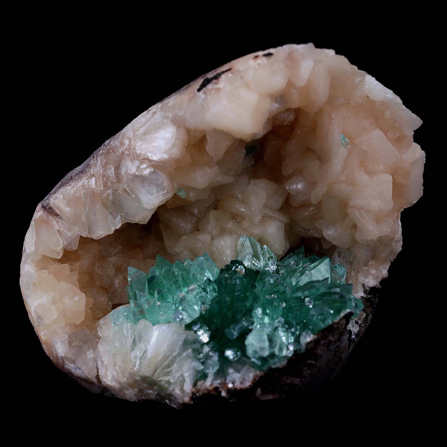 Green Apophyllite with Stilbite Natural Mineral Specimen # B 3986  https://www.superbminerals.us/products/green-apophyllite-with-stilbite-natural-mineral-specimen-b-3986  Features Transparent green apophyllite crystals up to 10-15 mm long with lustrous crystal faces and steep pyramidal terminations, on matrix covered with lustrous peach-baggie colored Stilbite crystals up to mixed size. Primary Mineral(s):&nbsp; Apophyllite Secondary Mineral(s): Stilbite