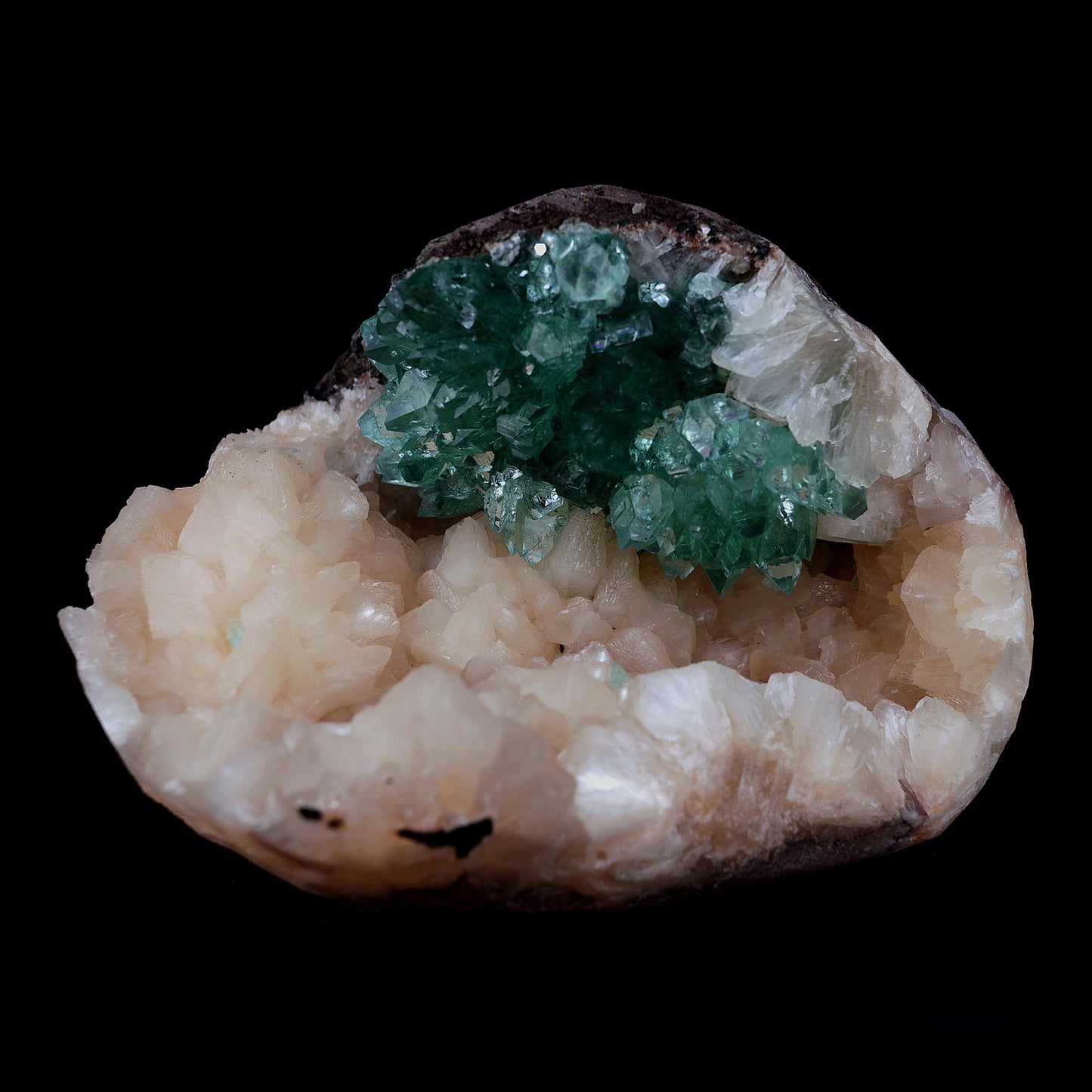 Green Apophyllite with Stilbite Natural Mineral Specimen # B 3986  https://www.superbminerals.us/products/green-apophyllite-with-stilbite-natural-mineral-specimen-b-3986  Features Transparent green apophyllite crystals up to 10-15 mm long with lustrous crystal faces and steep pyramidal terminations, on matrix covered with lustrous peach-baggie colored Stilbite crystals up to mixed size. Primary Mineral(s):&nbsp; Apophyllite Secondary Mineral(s): Stilbite