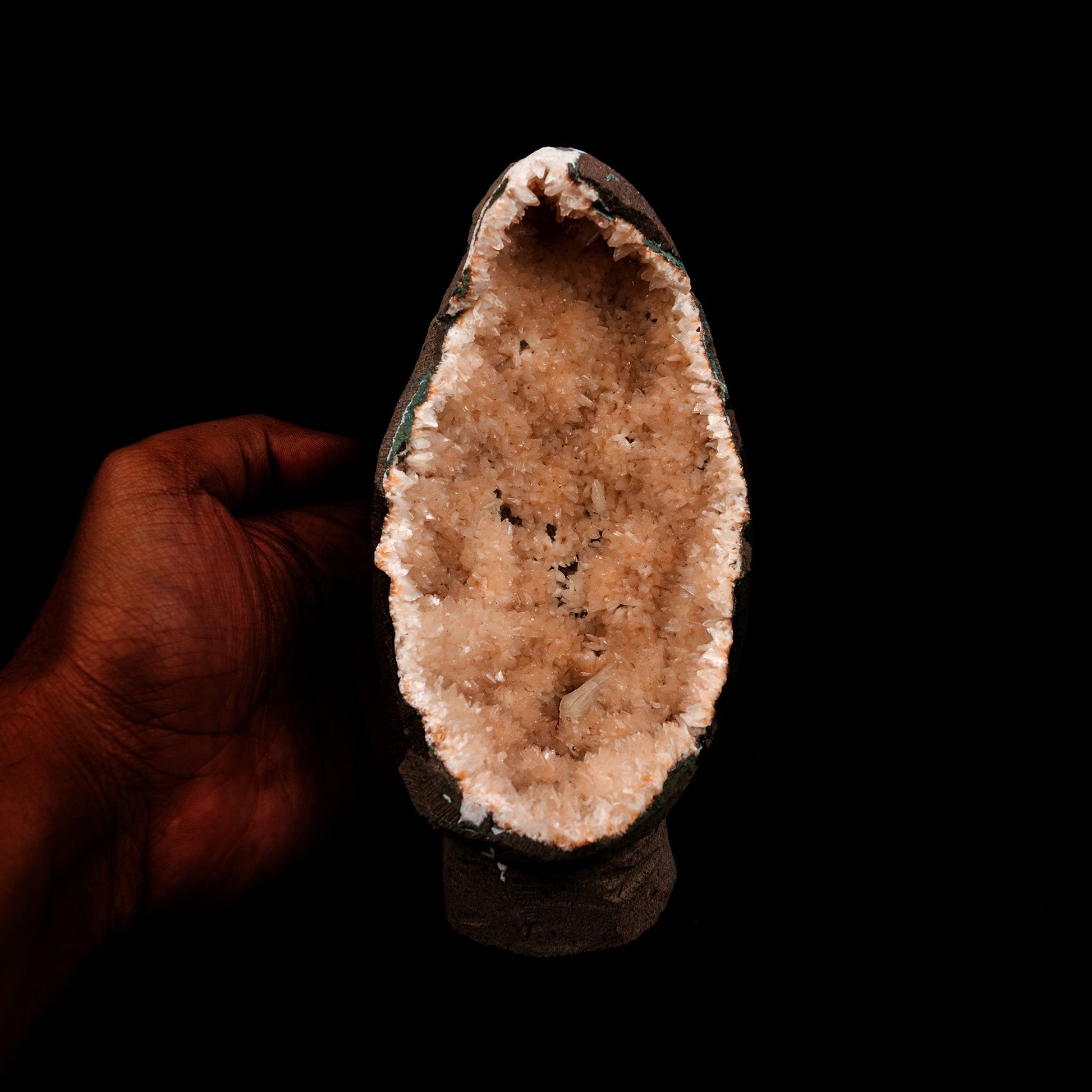 Helandite Geode Natural Mineral Specimen # B 5208  https://www.superbminerals.us/products/helandite-geode-natural-mineral-specimen-b-5208  Features: A nice aesthetic piece featuring a geode lined with lustrous, pink-orange Heulandite crystals. The crystals are well defined with a pearly, almost glassy luster. This piece sparkles. Excellent condition. Primary Mineral(s): HeulanditeSecondary Mineral(s): N/AMatrix: N/A 7 Inch x 3.5 InchWeight : 782 