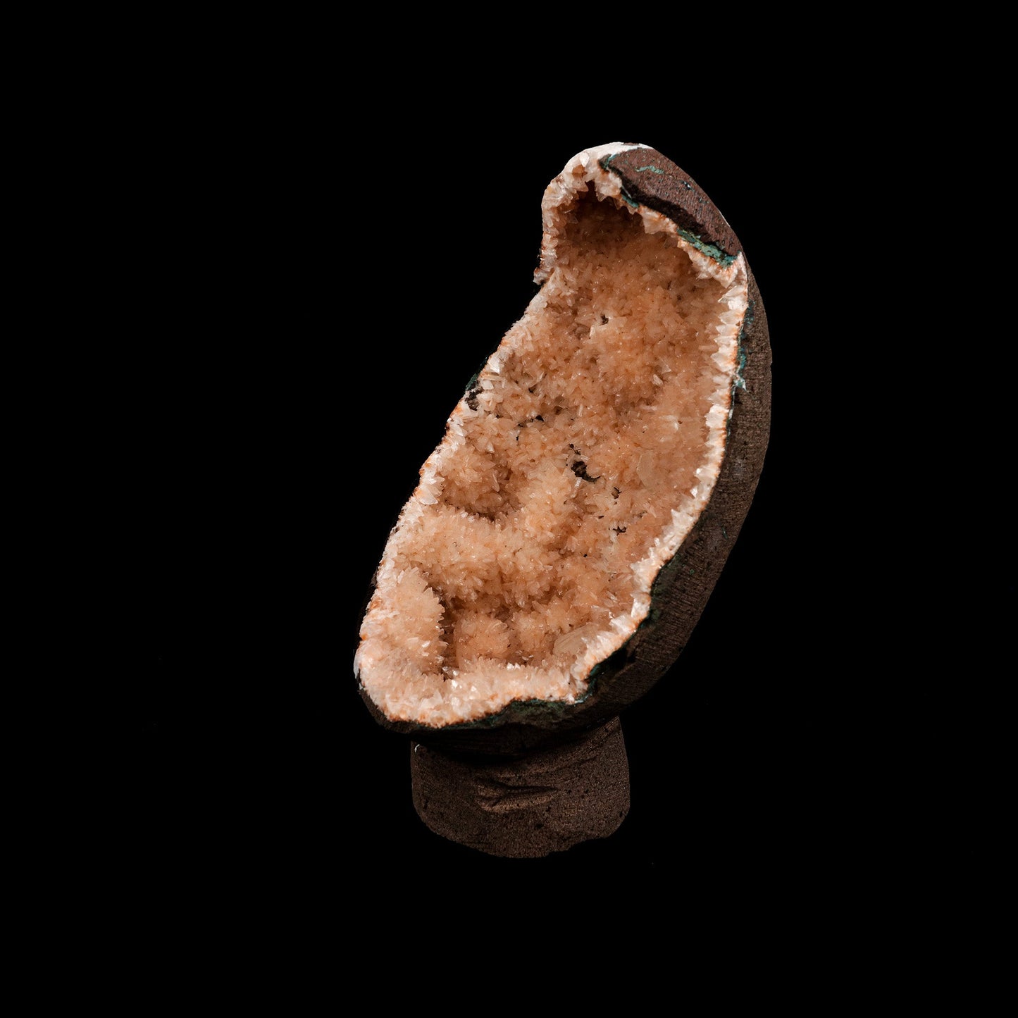 Helandite Geode Natural Mineral Specimen # B 5208  https://www.superbminerals.us/products/helandite-geode-natural-mineral-specimen-b-5208  Features: A nice aesthetic piece featuring a geode lined with lustrous, pink-orange Heulandite crystals. The crystals are well defined with a pearly, almost glassy luster. This piece sparkles. Excellent condition. Primary Mineral(s): HeulanditeSecondary Mineral(s): N/AMatrix: N/A 7 Inch x 3.5 InchWeight : 782 