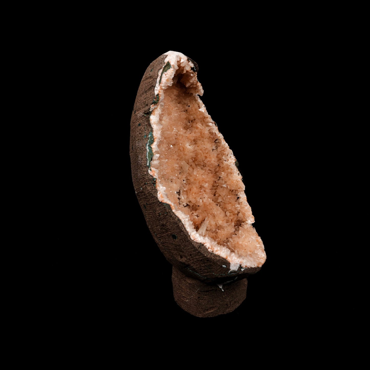 Helandite Geode Natural Mineral Specimen # B 5208  https://www.superbminerals.us/products/helandite-geode-natural-mineral-specimen-b-5208  Features: A nice aesthetic piece featuring a geode lined with lustrous, pink-orange Heulandite crystals. The crystals are well defined with a pearly, almost glassy luster. This piece sparkles. Excellent condition. Primary Mineral(s): HeulanditeSecondary Mineral(s): N/AMatrix: N/A 7 Inch x 3.5 InchWeight : 782 