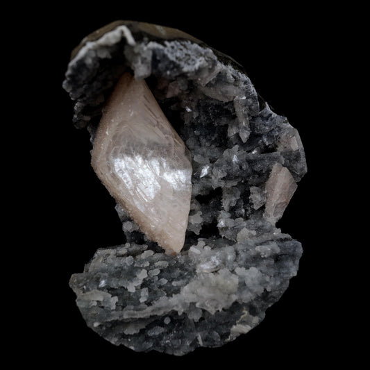 Heulandite Crystal Inside Black Chalcedony Geode Natural Mineral Speci…  https://www.superbminerals.us/products/heulandite-crystal-inside-black-chalcedony-geode-natural-mineral-specimen-b-4491  Features:A stunning wedge heulandite crystal is forcefully placed in a sculptural, well-prepared basalt vug bordered with a sharply contrasting sparkling grey drusy chalcedony.The magnificent glassy, iridescent, transparent parallel-growth bladed heulandite has a lovely rich coral-pink hue with unique curving 
